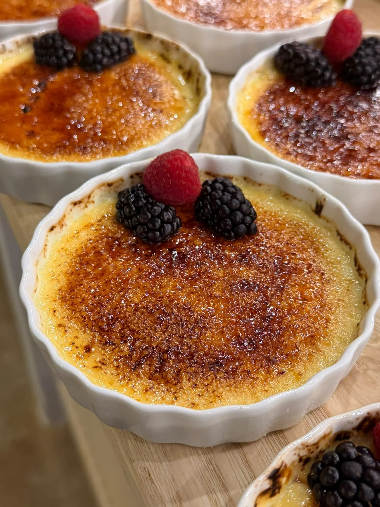 Crème brûlée topped with fresh berries, made by a private chef in Mallorca