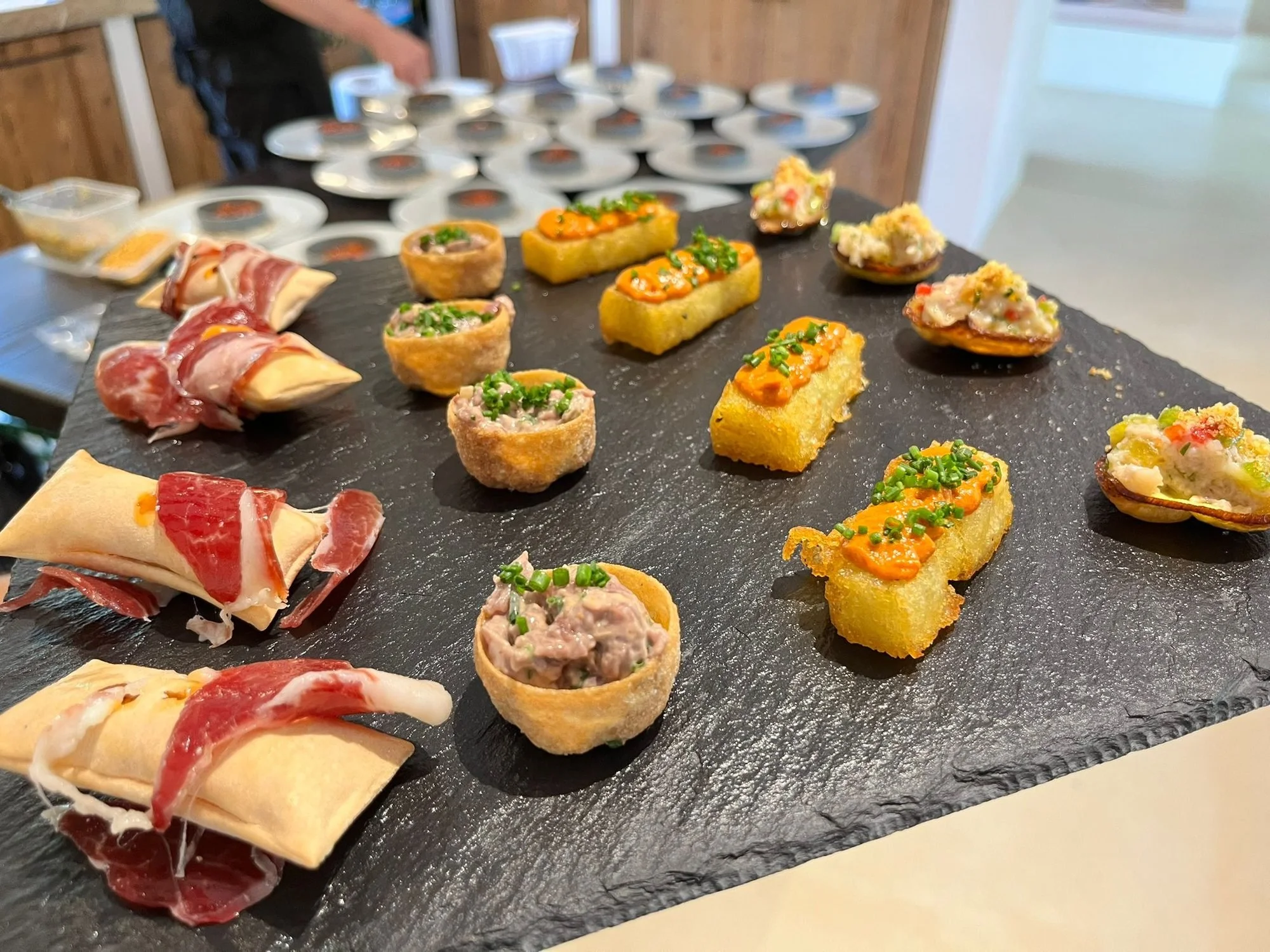 Selection of canapés on a slate board for a celebration aperitivo in Mallorca