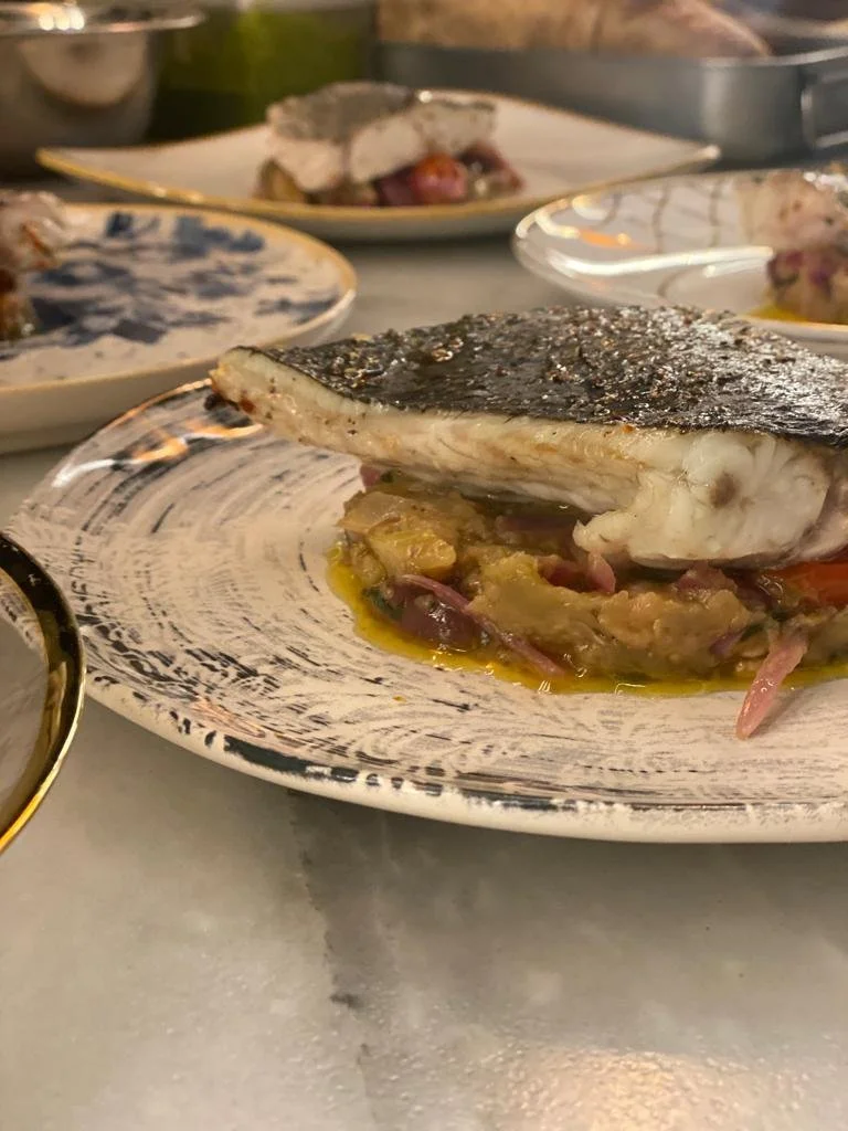 Plated Mediterranean sea bass main course, prepared by a private chef for a dinner in Mallorca