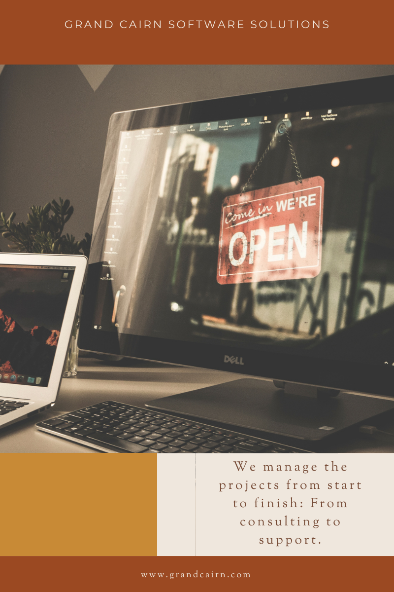 Brochure for Grand Cairn Software Solutions with picture of an open sign on a computer monitor and a laptop on a desk.