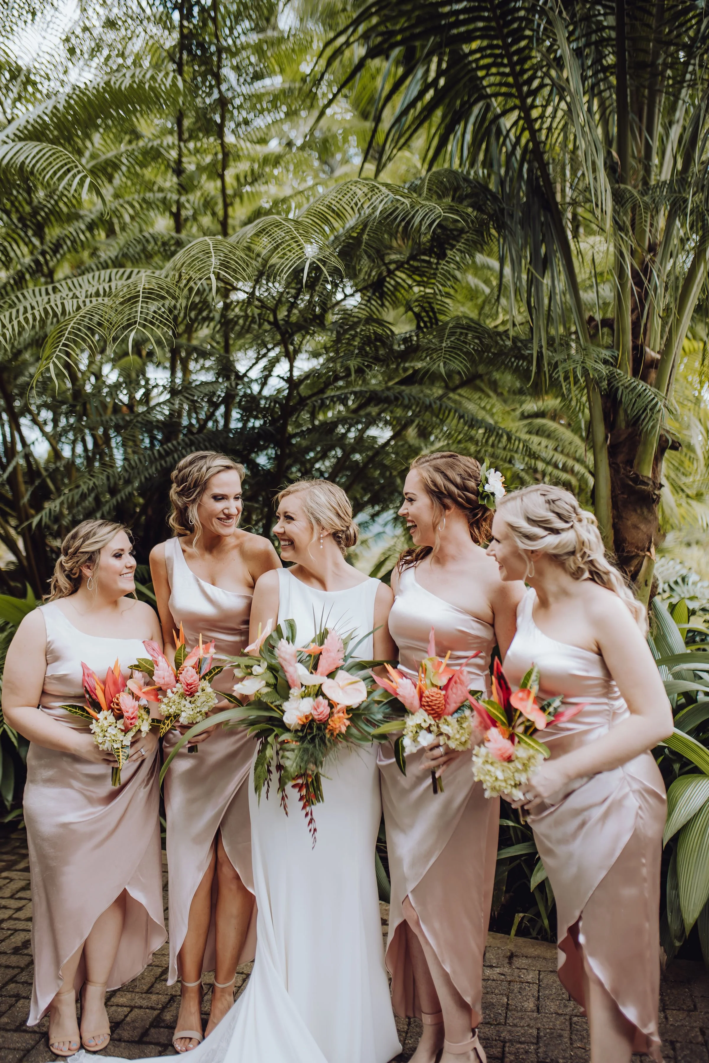 Enchanting pastel wedding party with whimsical elements and vibrant tropical flowers.
