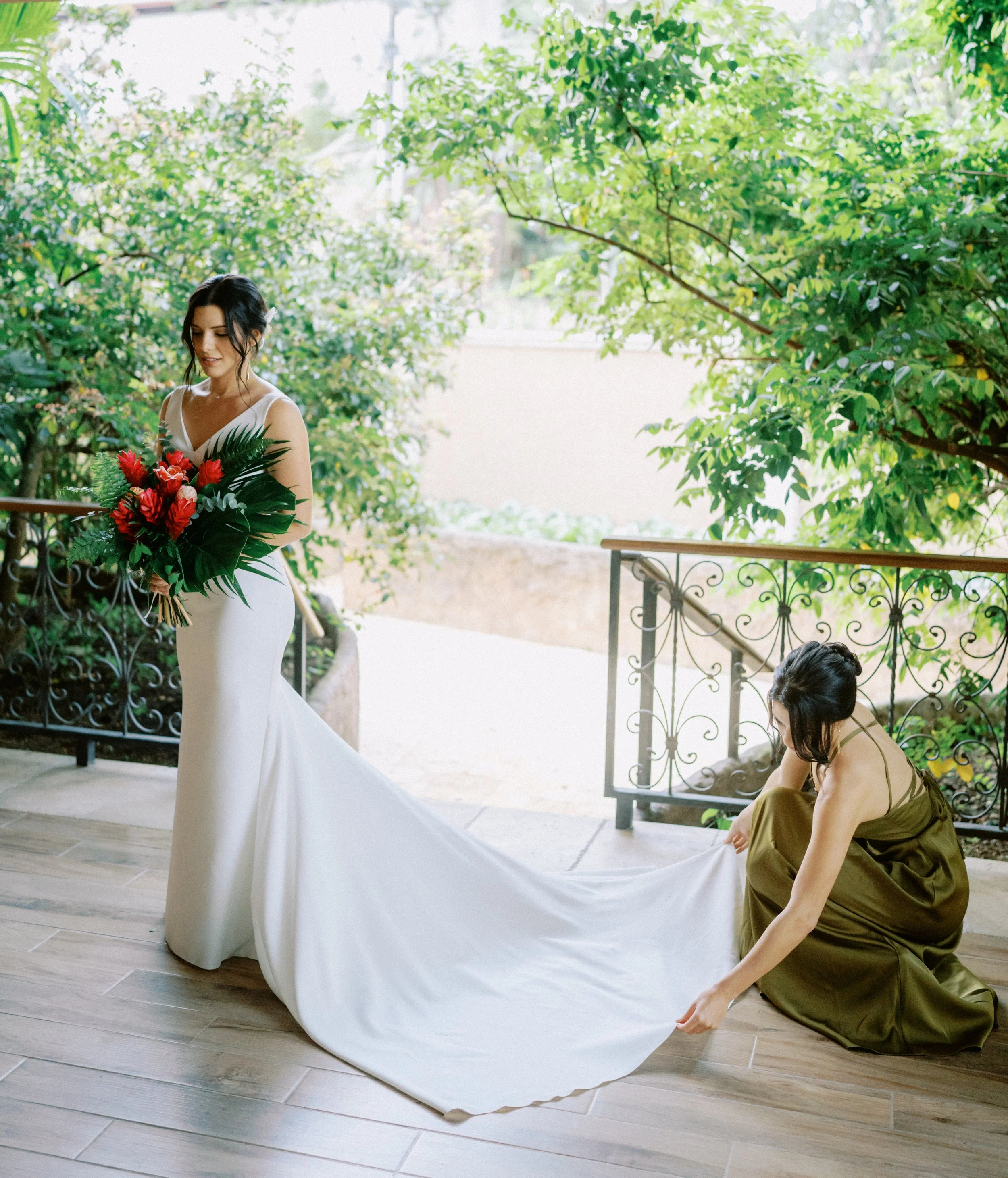 Romantic ceremony bride and maid of honor beside the Arenal River with the volcano backdrop
