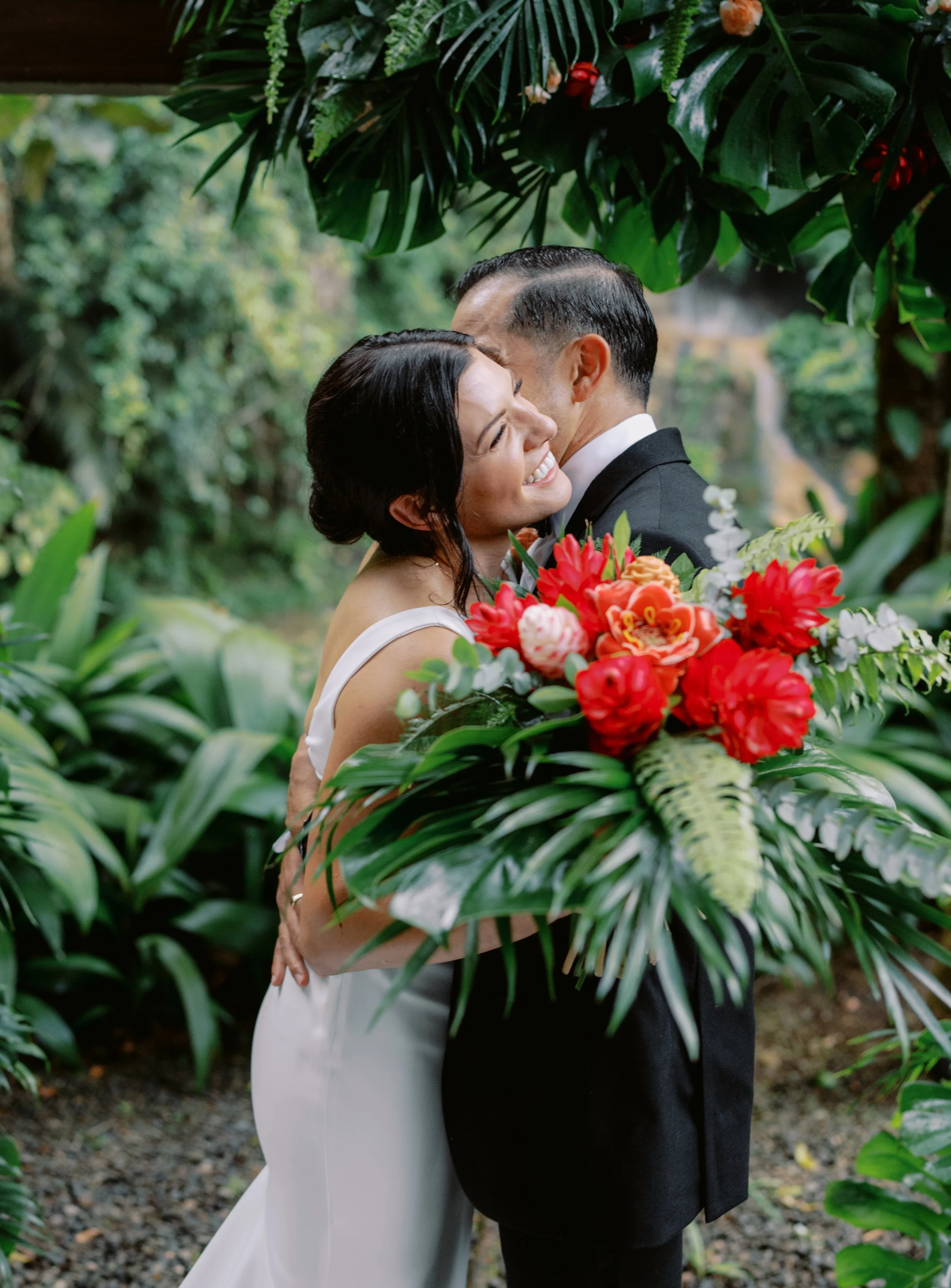 Tropical destination wedding with Arenal Volcano's majestic views and riverfront setting.