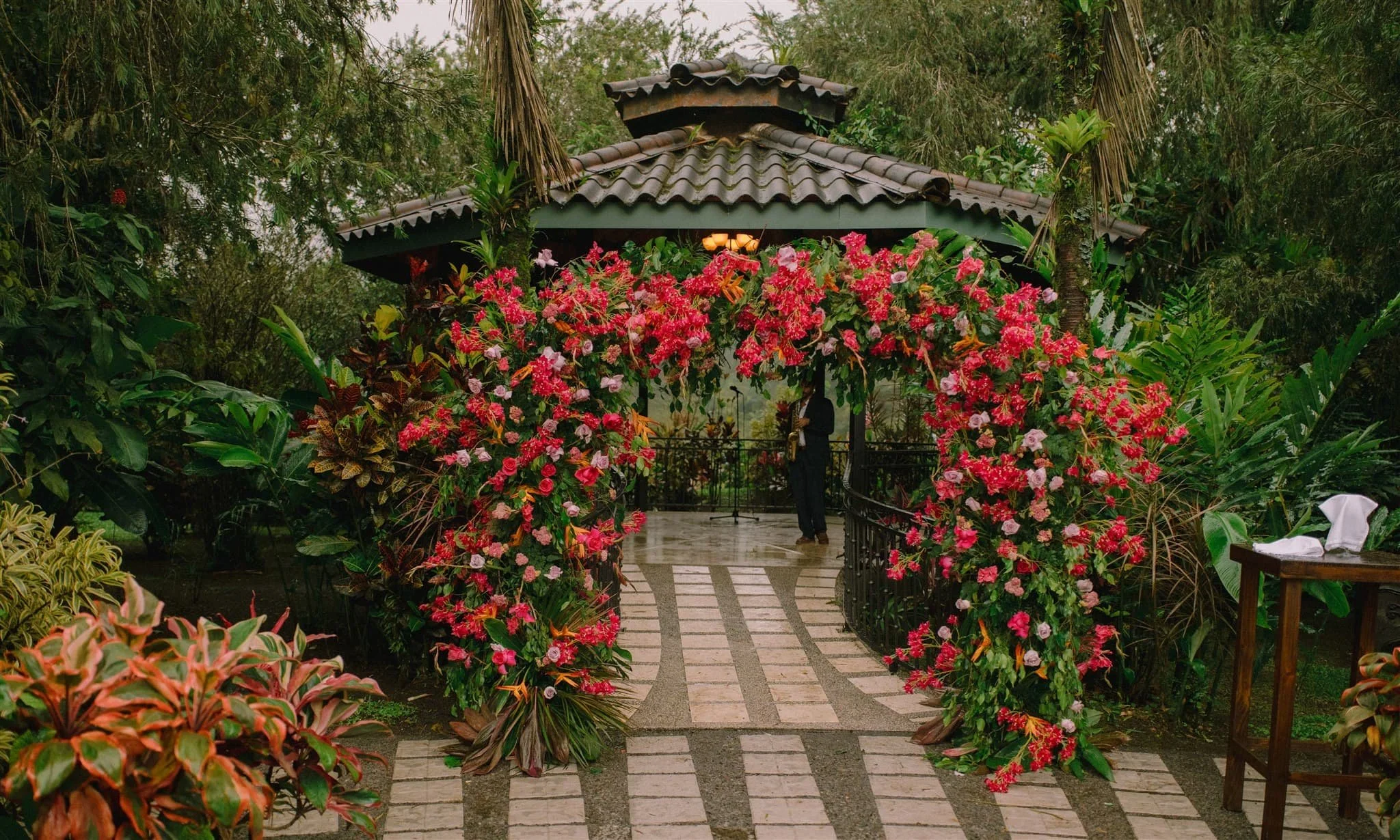 pink and red flower arch for a destination wedding ceremony in costa rica
