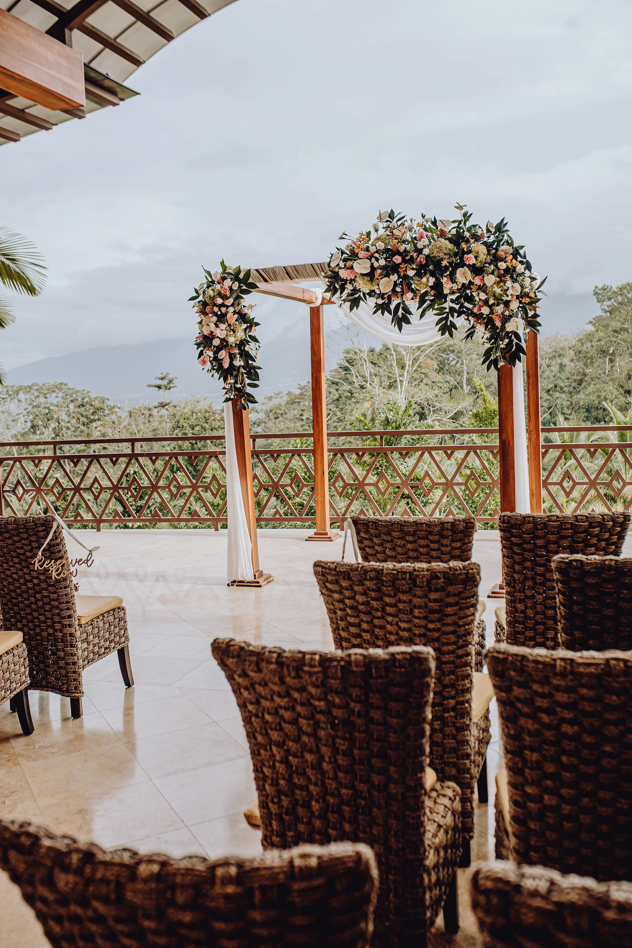 A dreamy pastel and tropical wedding combining soft hues with vibrant nature.