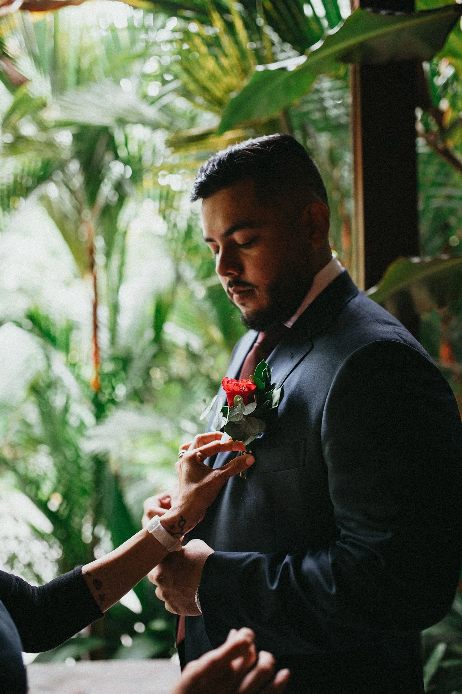 Groom in a blue suit getting ready for the wedding