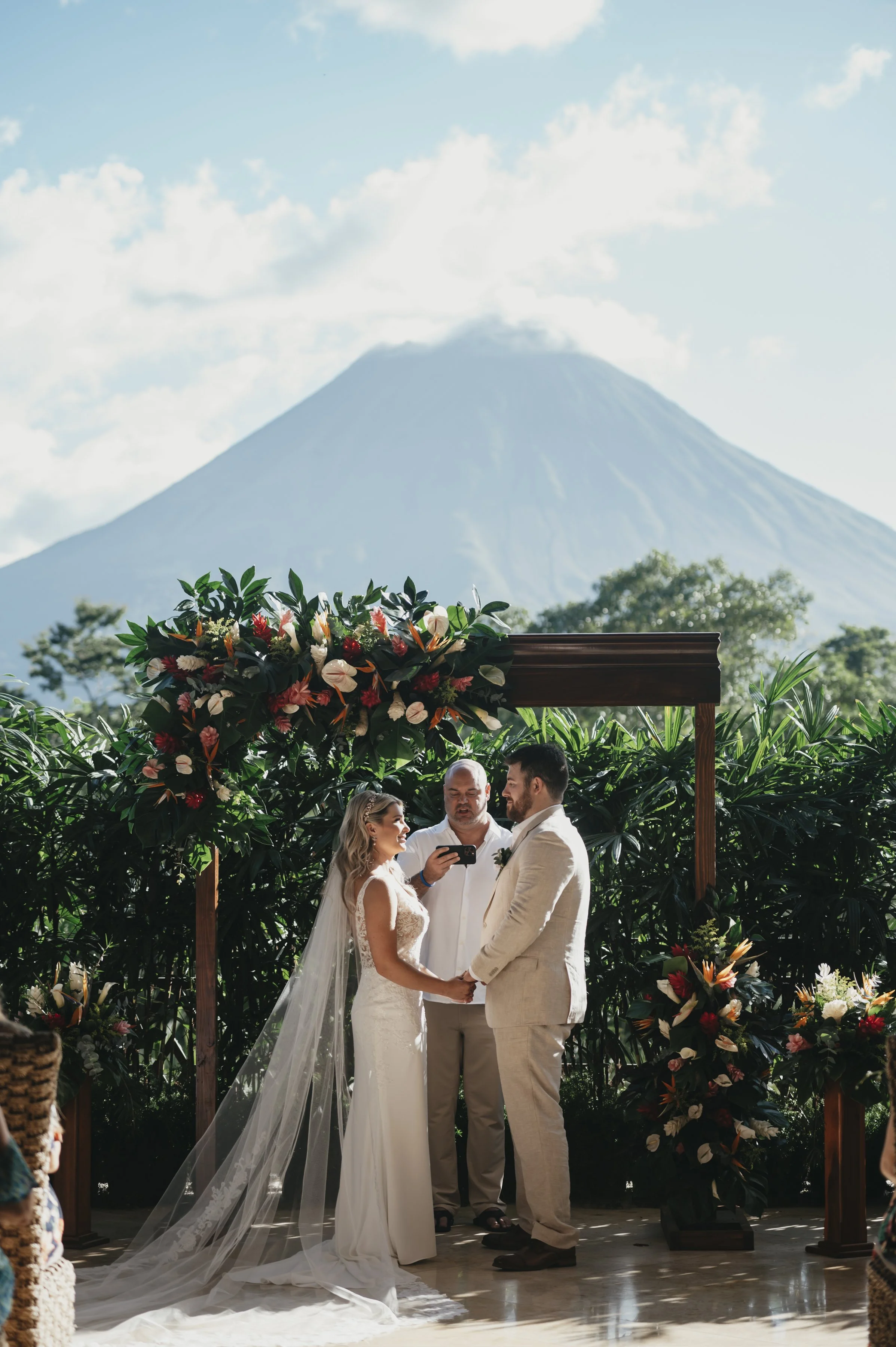 A tropical, intimate wedding setting under the warm sun and lush palm trees