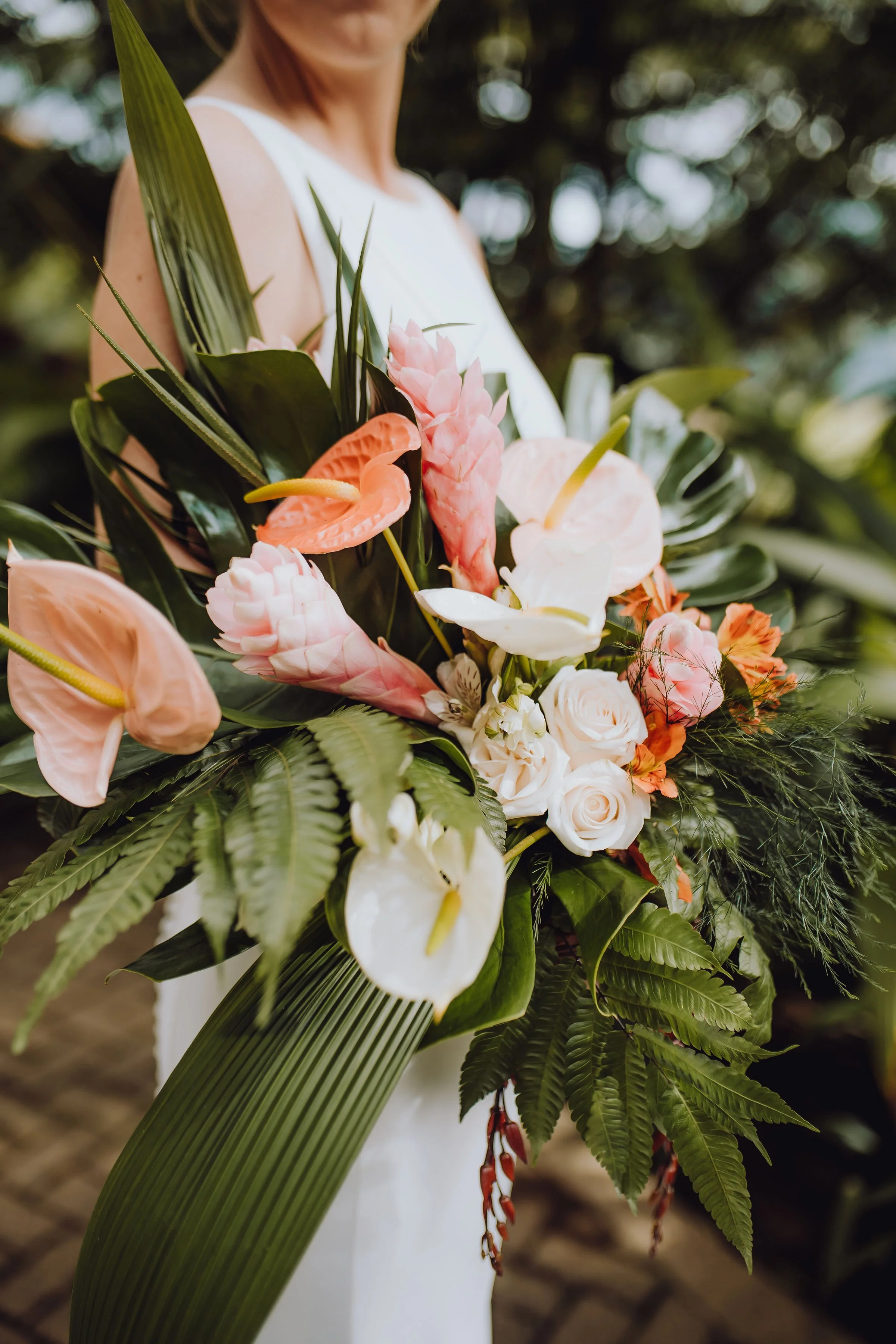 Whimsical pastel wedding with tropical accents, capturing nature’s romantic beauty.