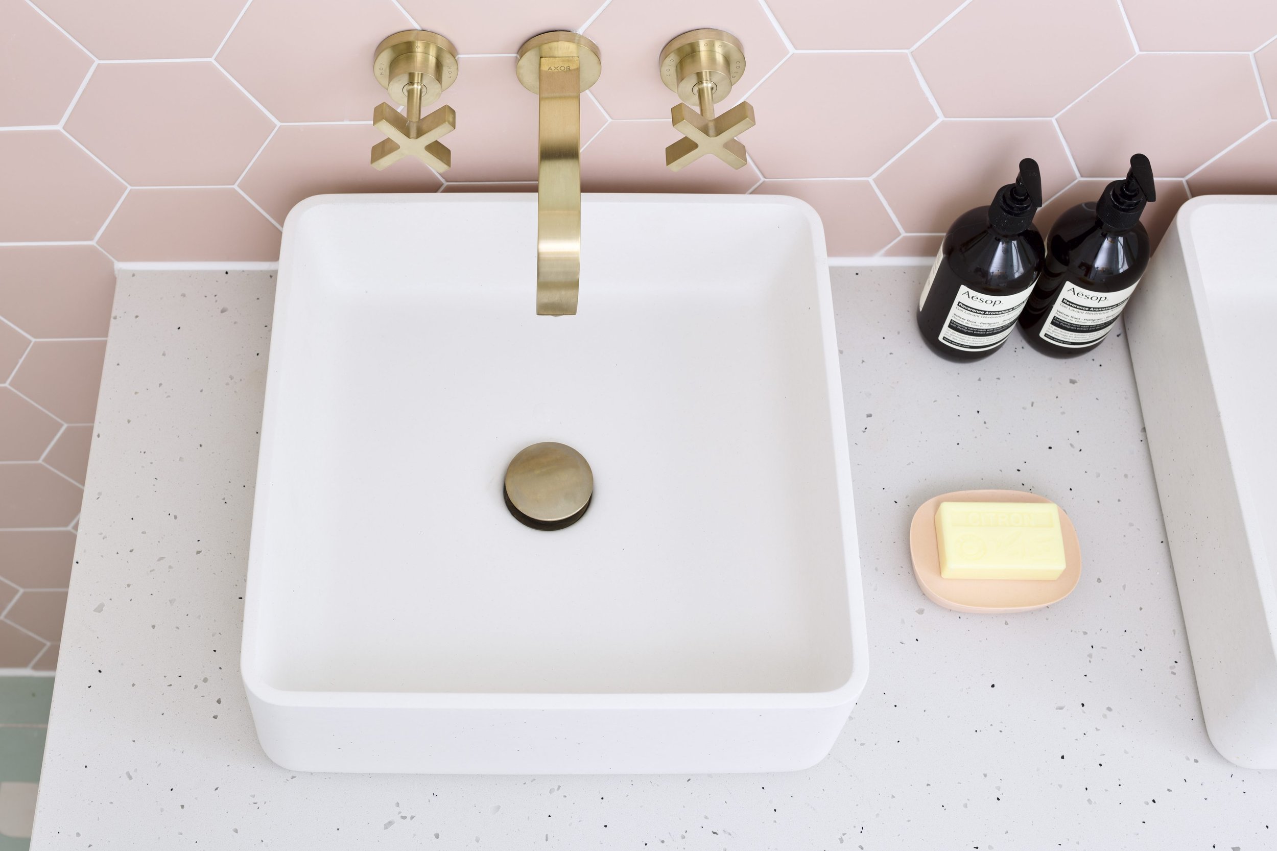 square concrete basin with brushed brass brassware