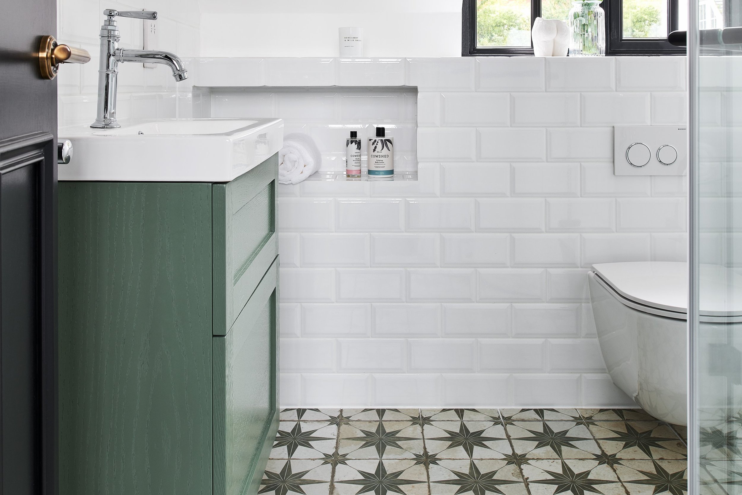 chrome hand shower with white gloss metro tiles