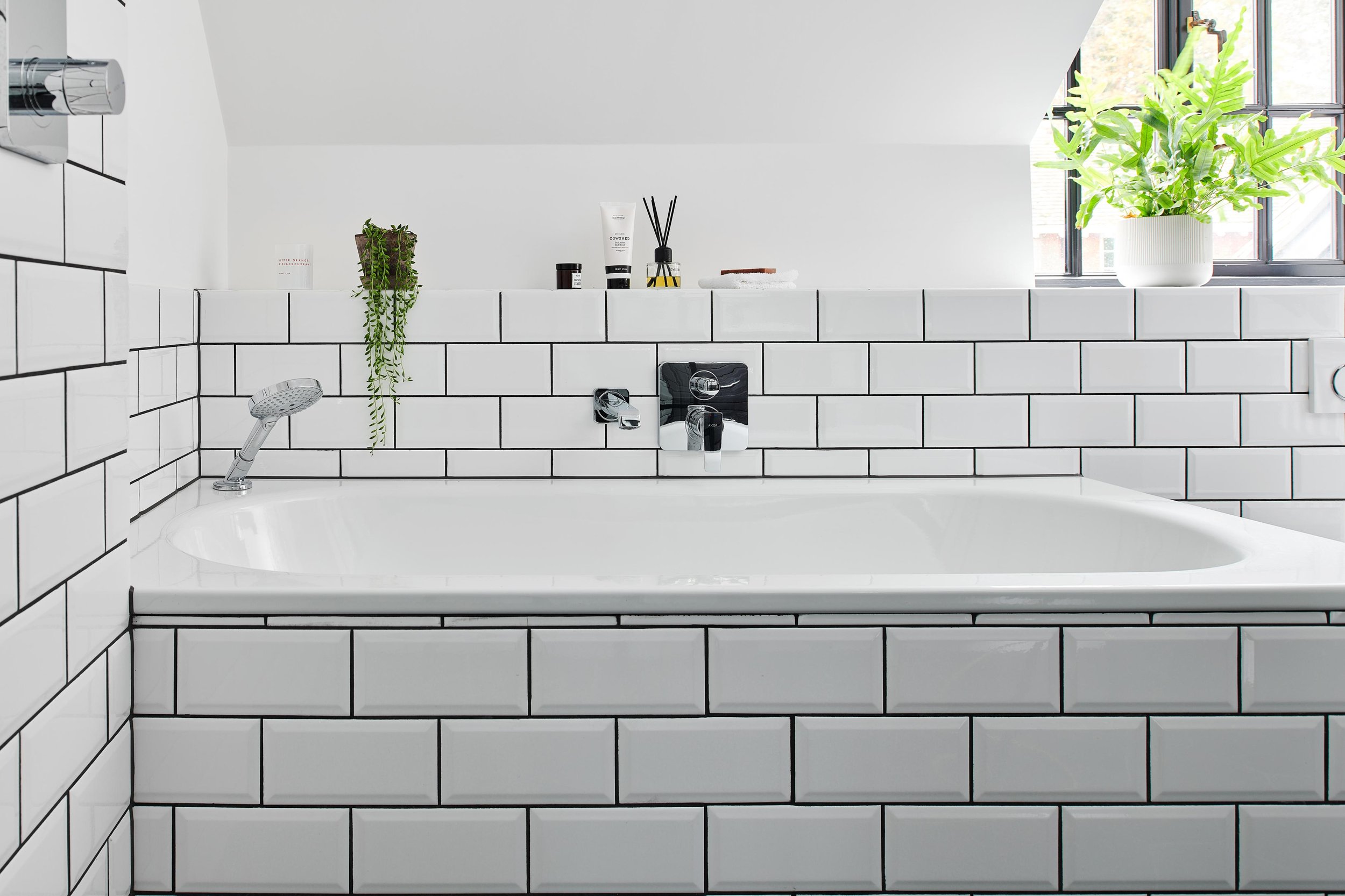 bath with white metro tiles and grey grout