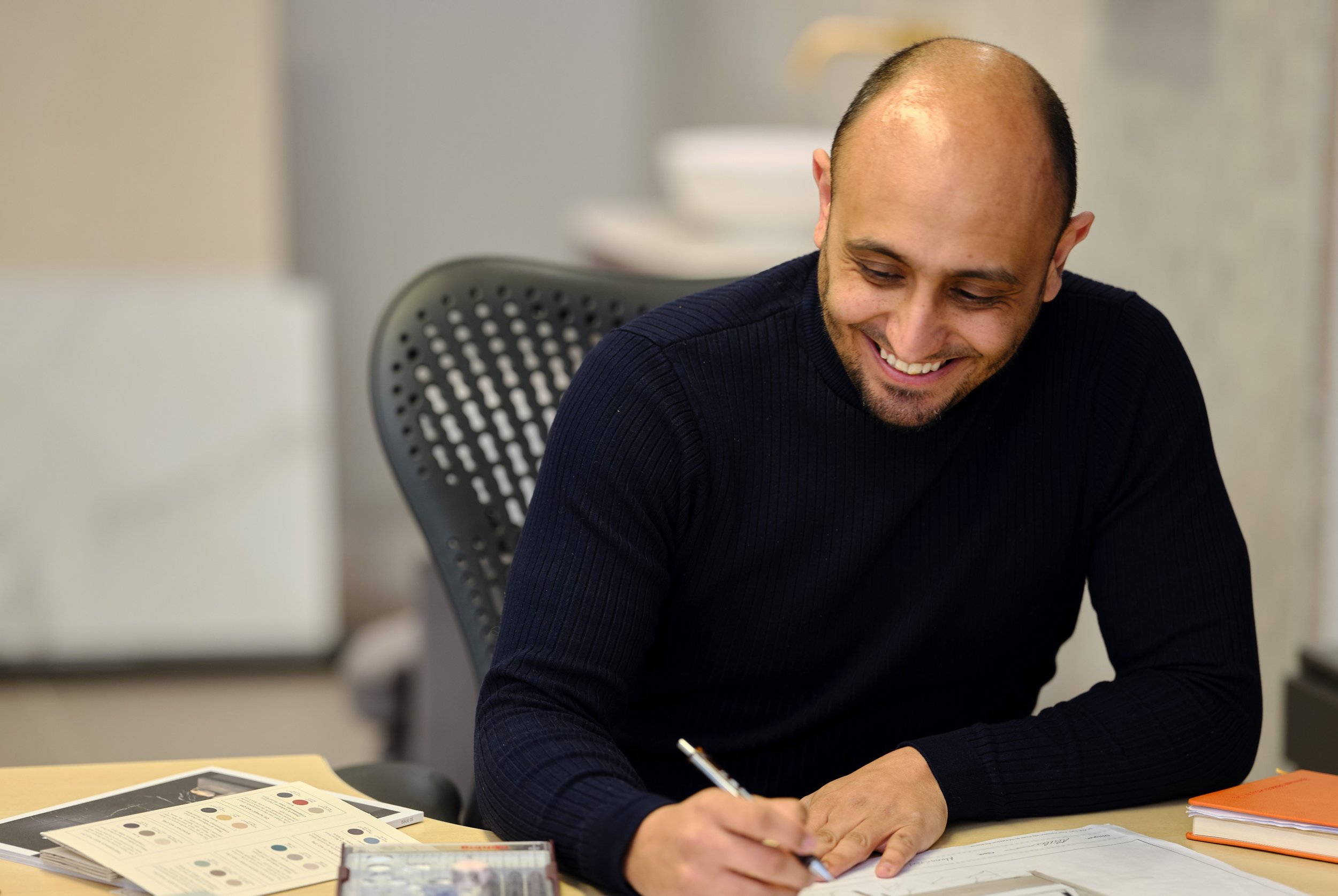 A Ripples Designer smiling and drawing bathroom designs