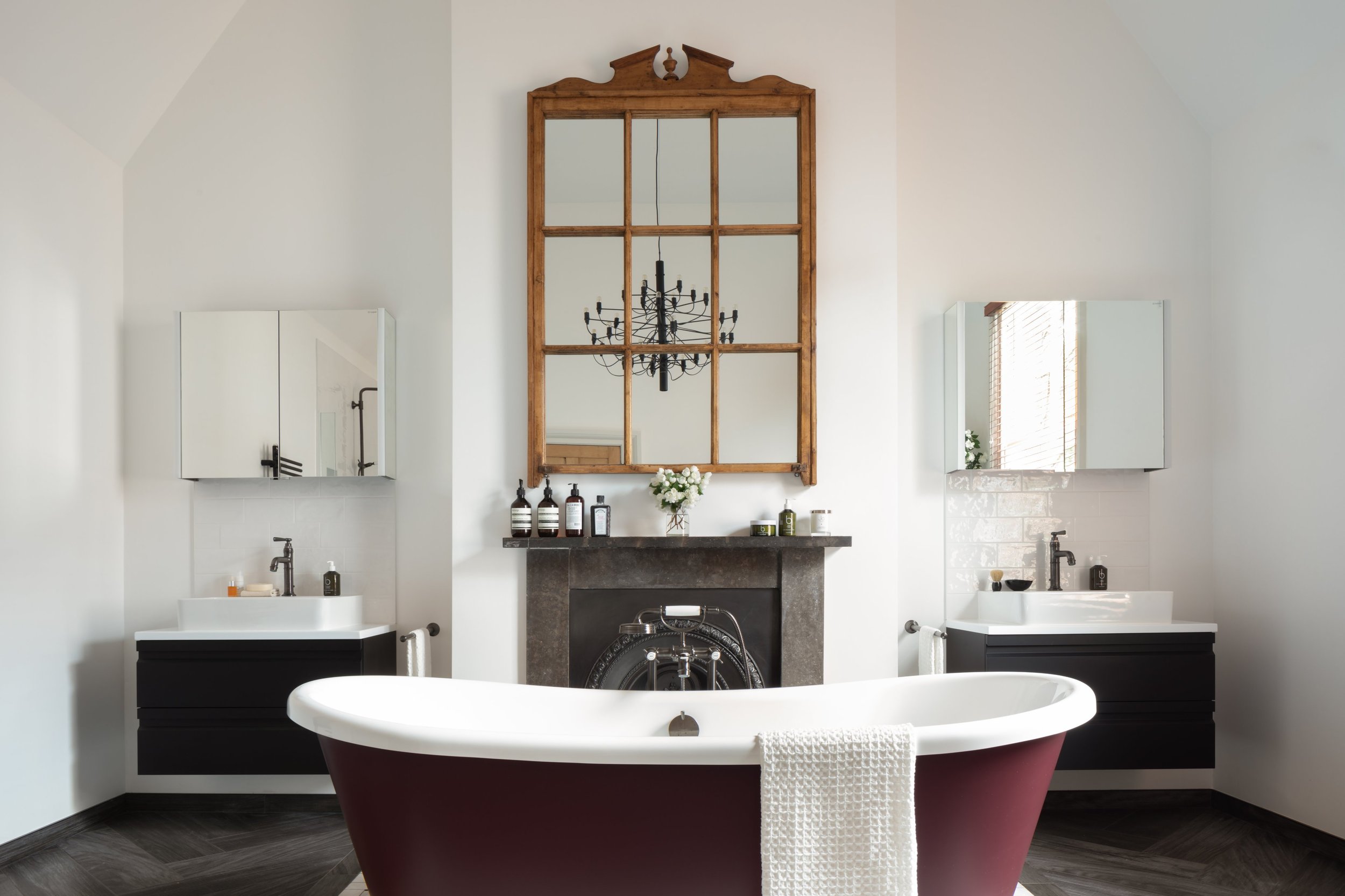 traditional bathroom with rolltop bath and wooden mirror