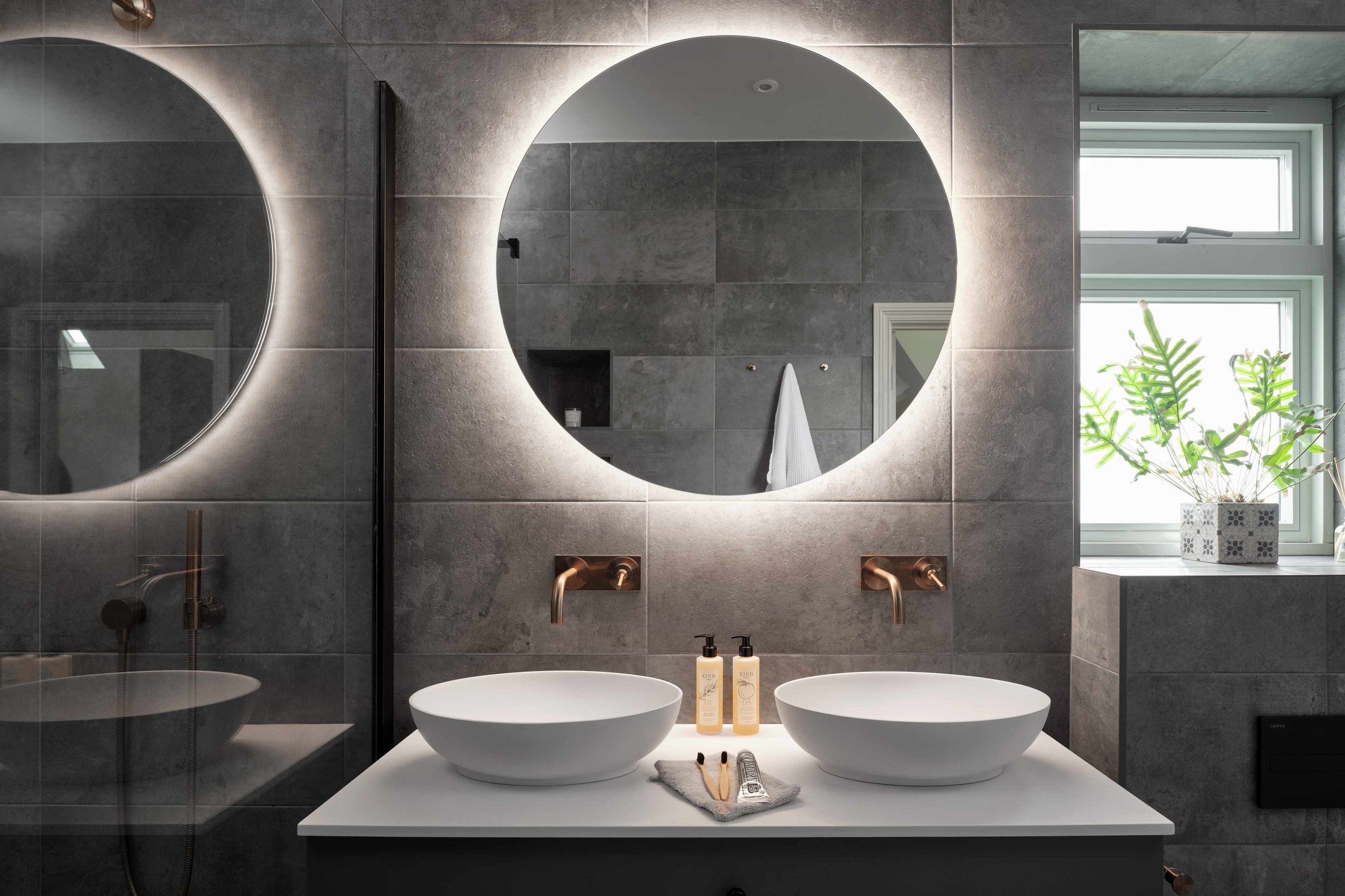 bathroom-with-led-lit-mirror-and-matching-sit-on-sinks.jpg