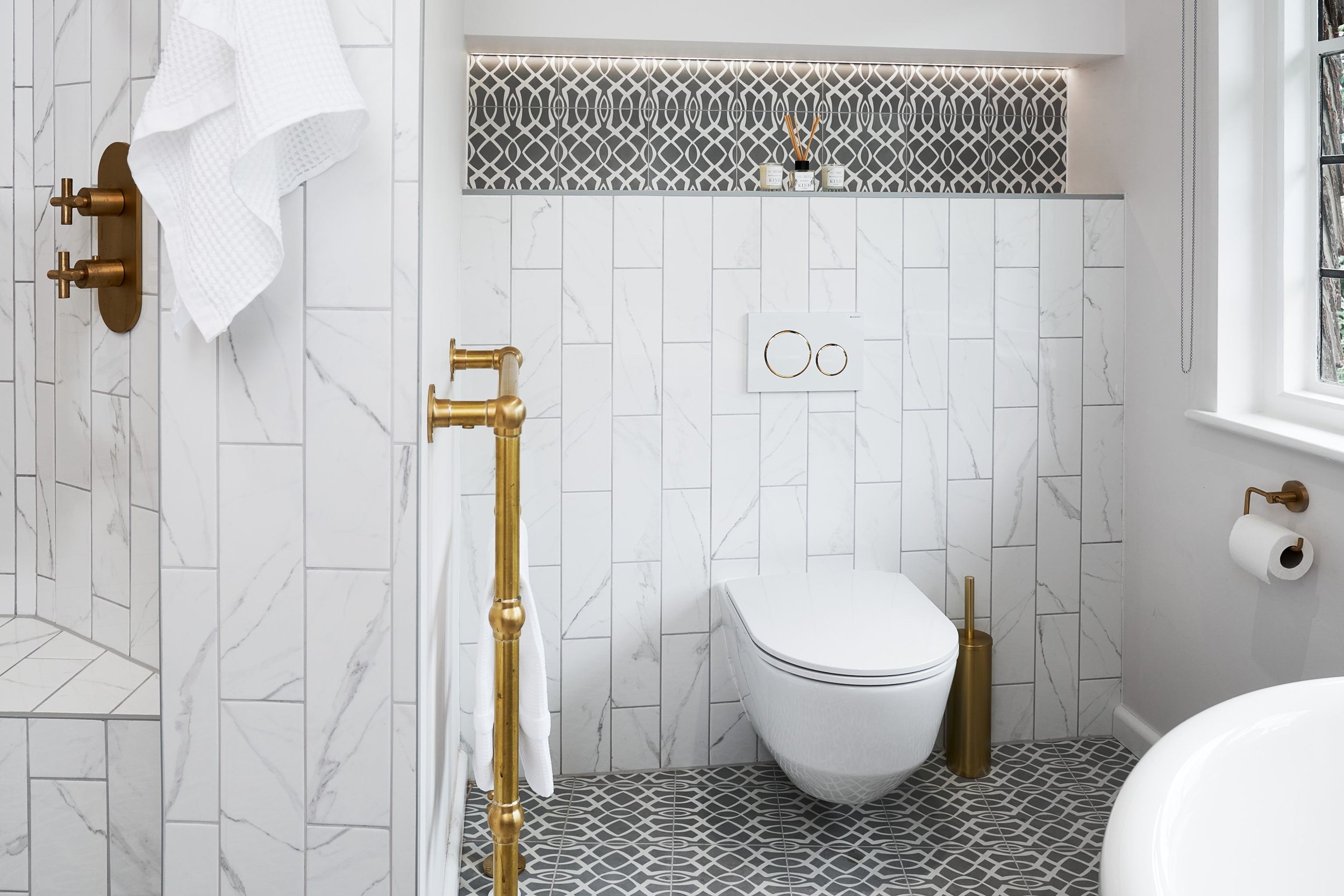 wall-hung-wc-with-mixed-tiles-and-gold-brassware.jpg
