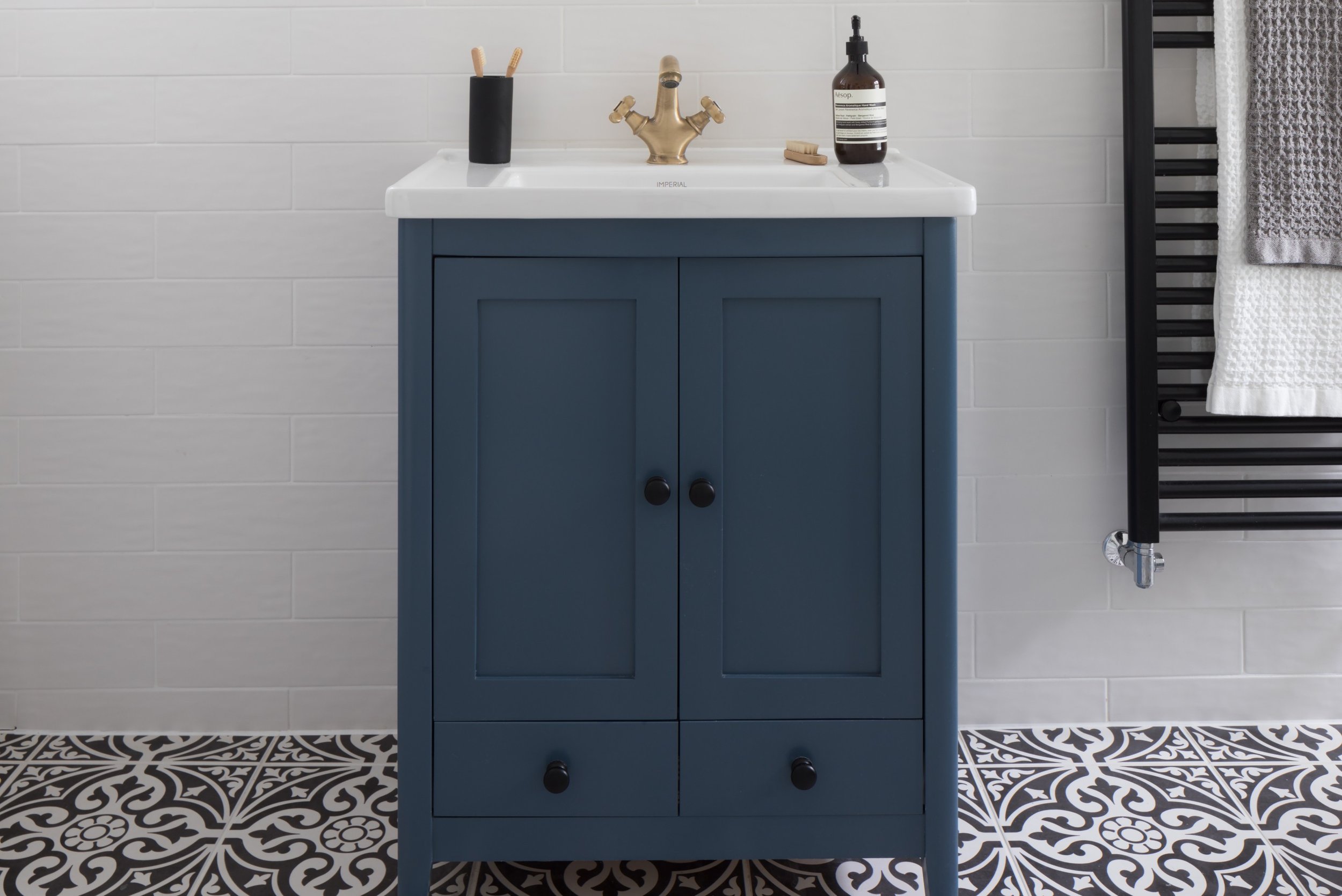 blue-vanity-unit-with-patterned-monochrome-tiled-floor.jpg