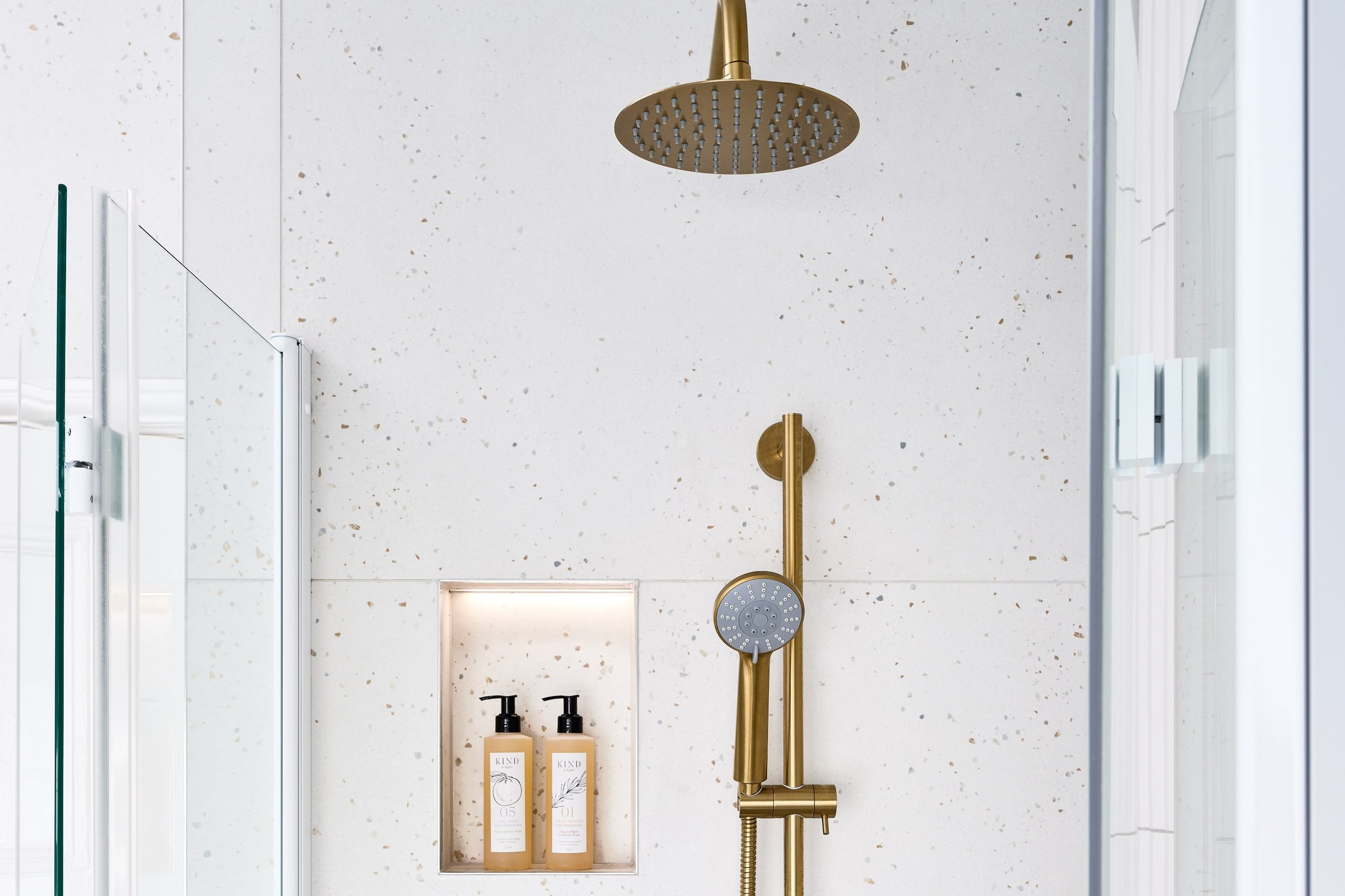 close-up-of-brushed-gold-shower-with-storage-niche.jpg