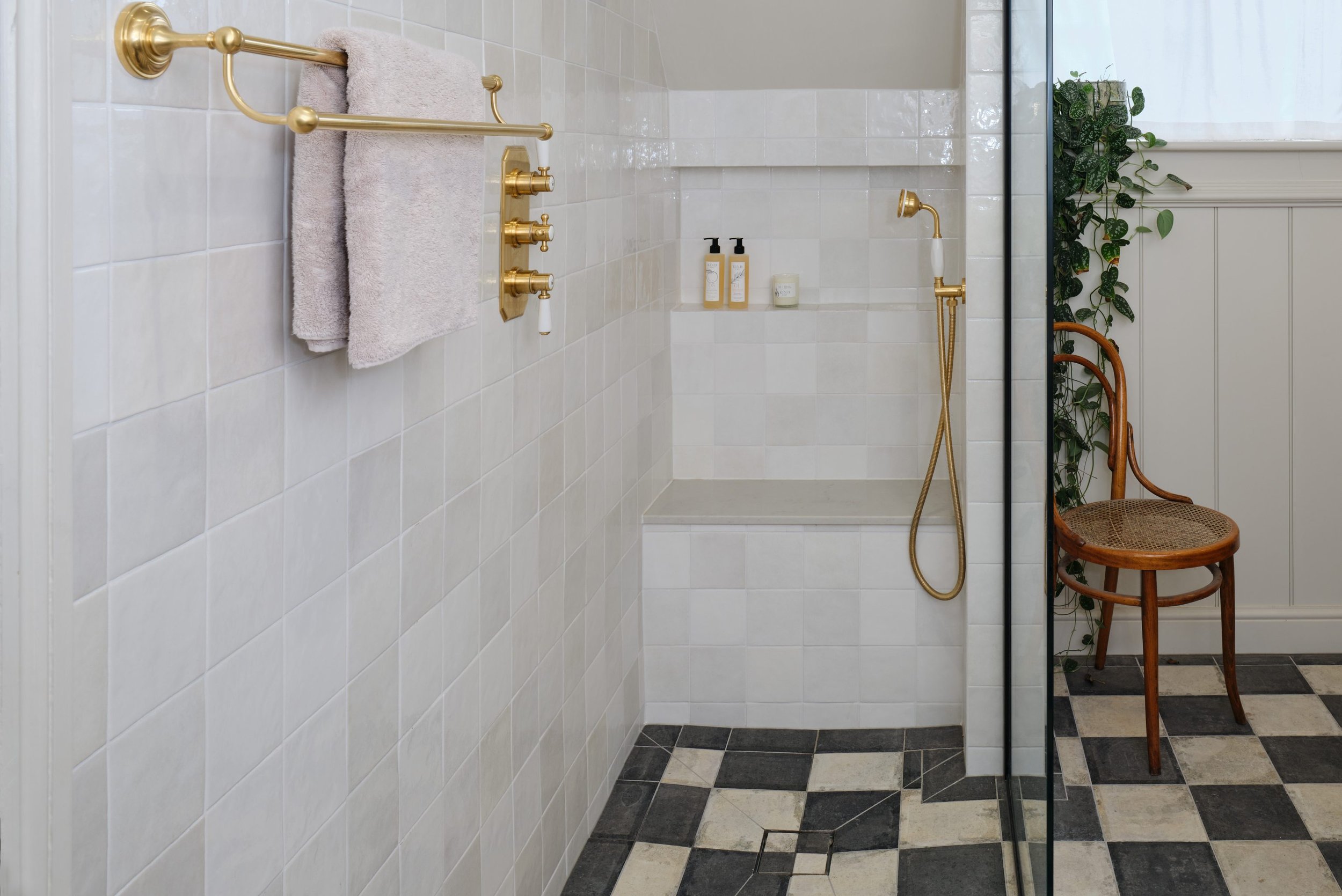 shower-area with-chequered-bathroom-floor-and-gold-brassware.jpg
