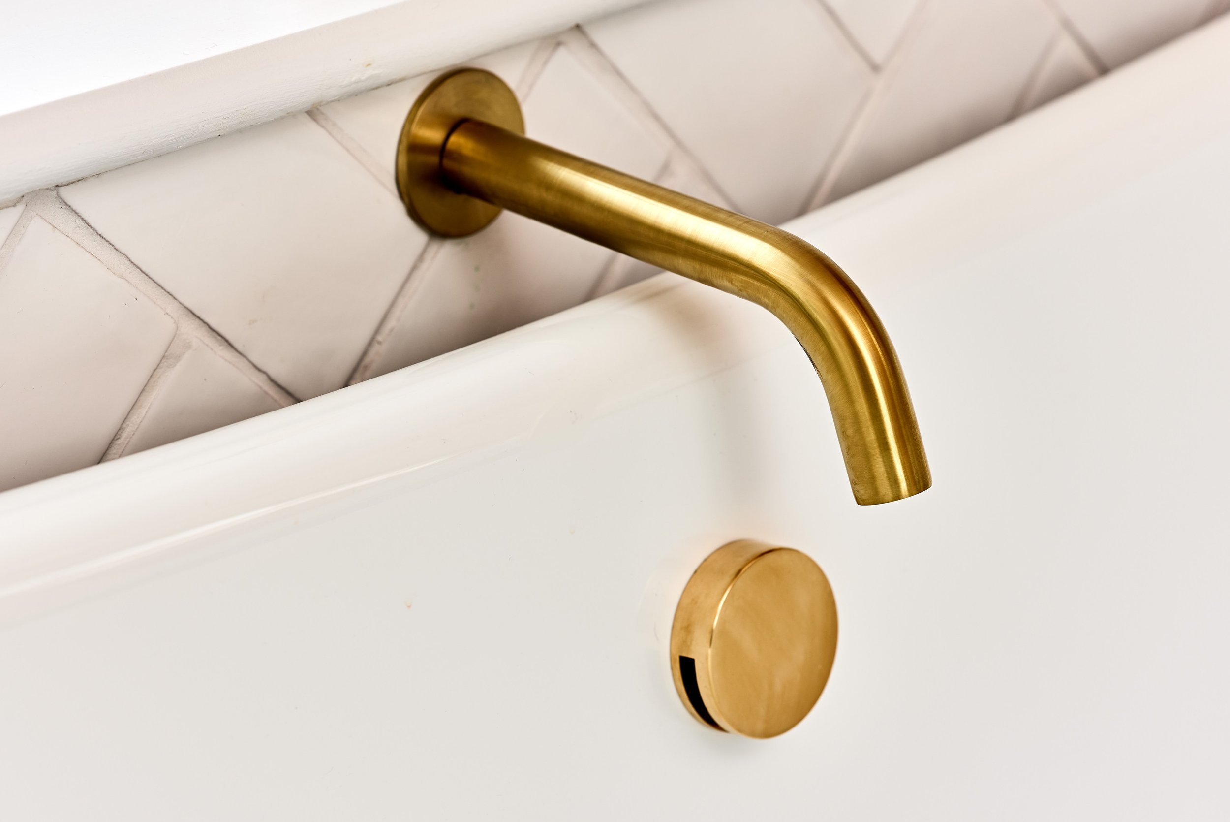 close-up-of-brushed-brass-tap-above-bath.jpg