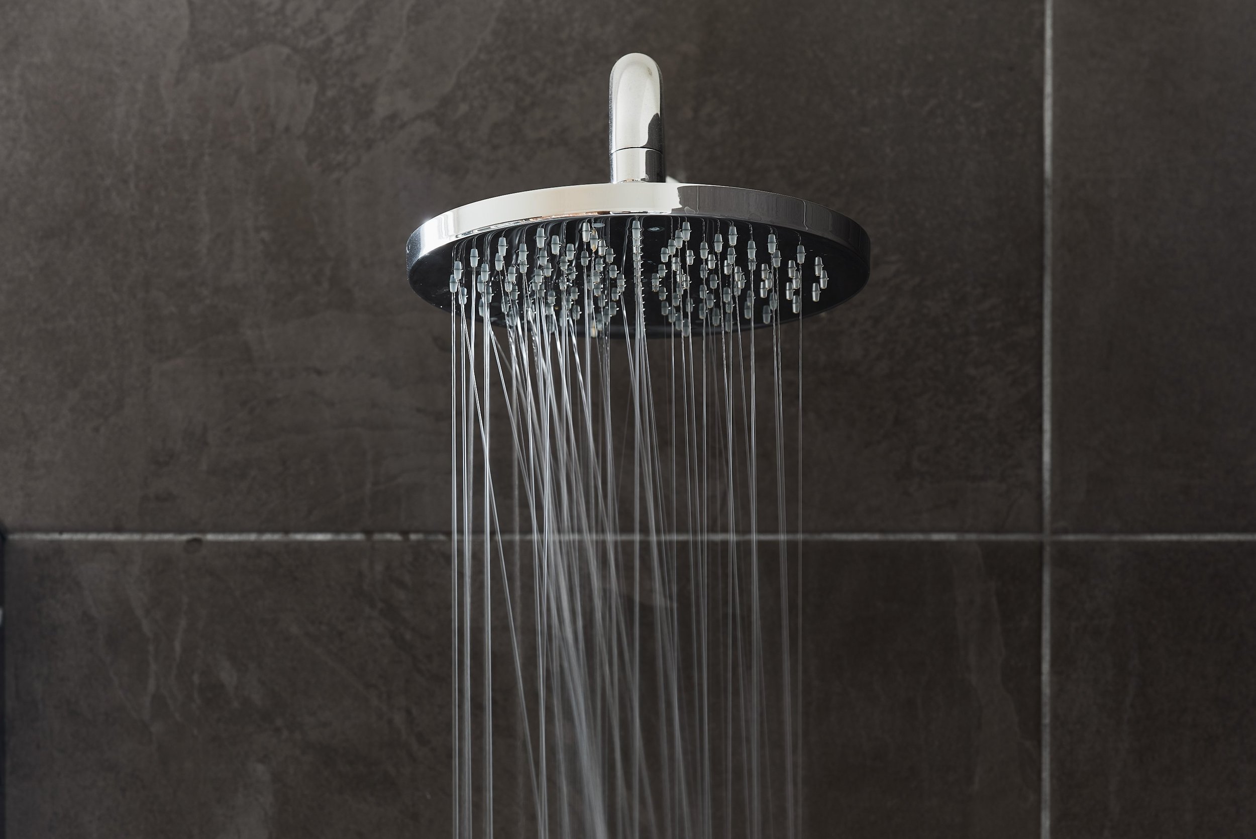 close-up-of-shower-with-running-water-in-ripples-bathroom.jpg