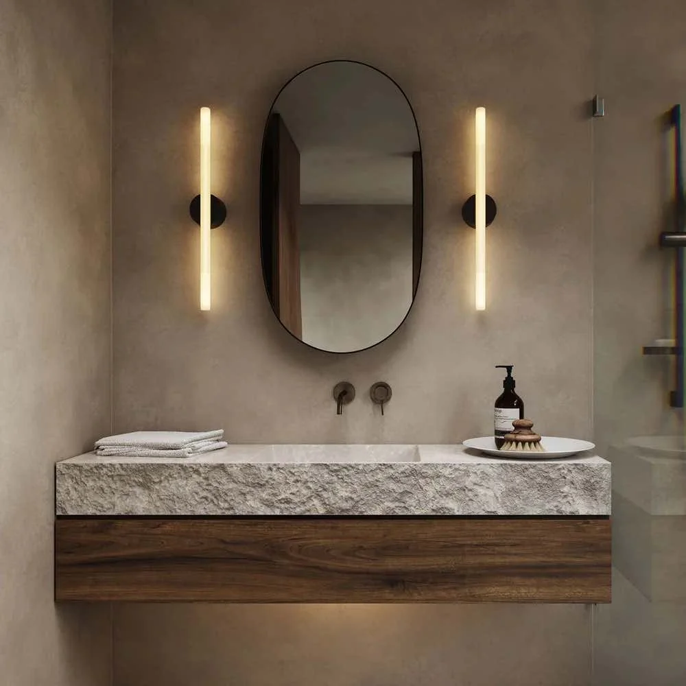 bathroom stone basin with oval mirror and two Tbar shaped lights either side