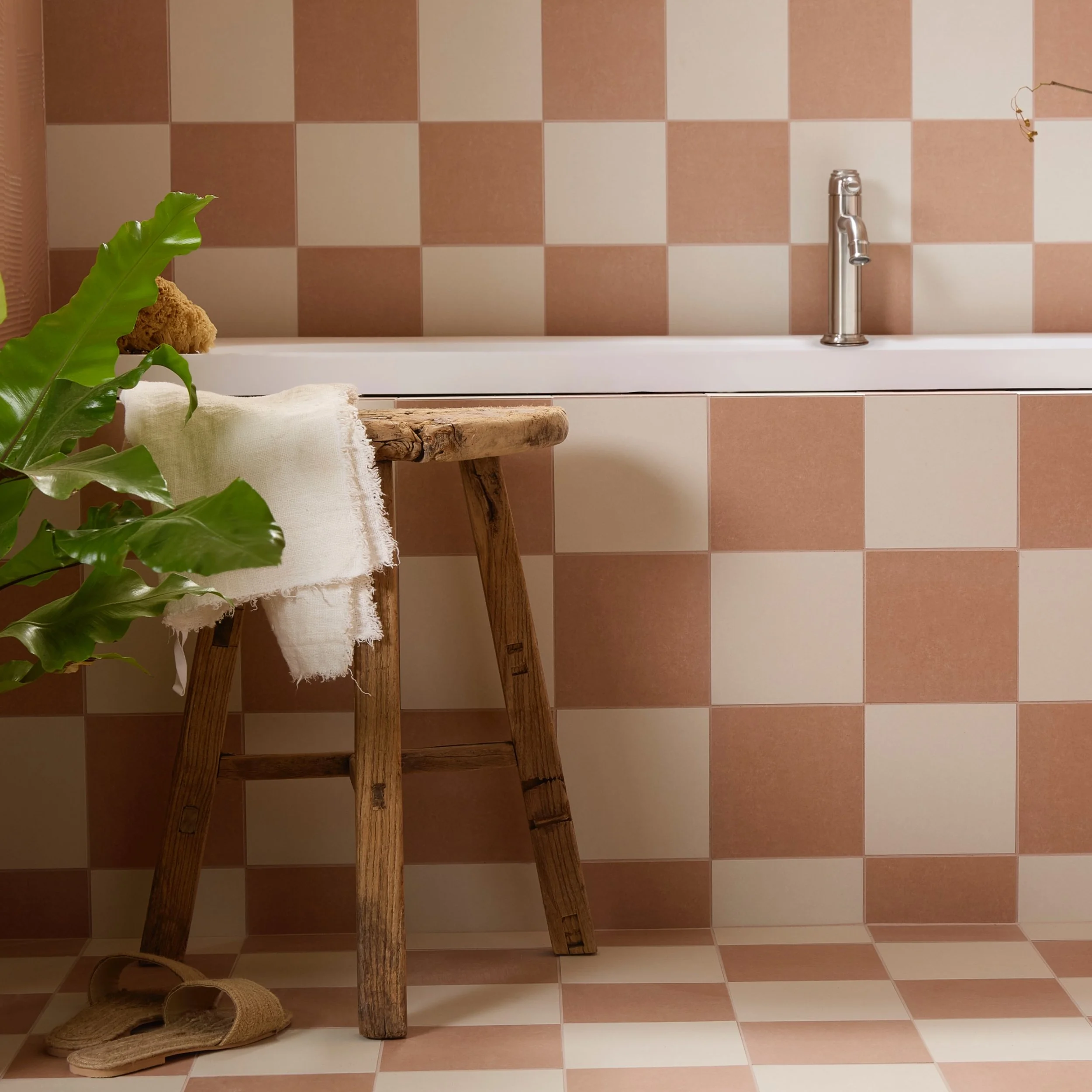 bath with alternating terracotta and ecru square tiles, along bath and wall.