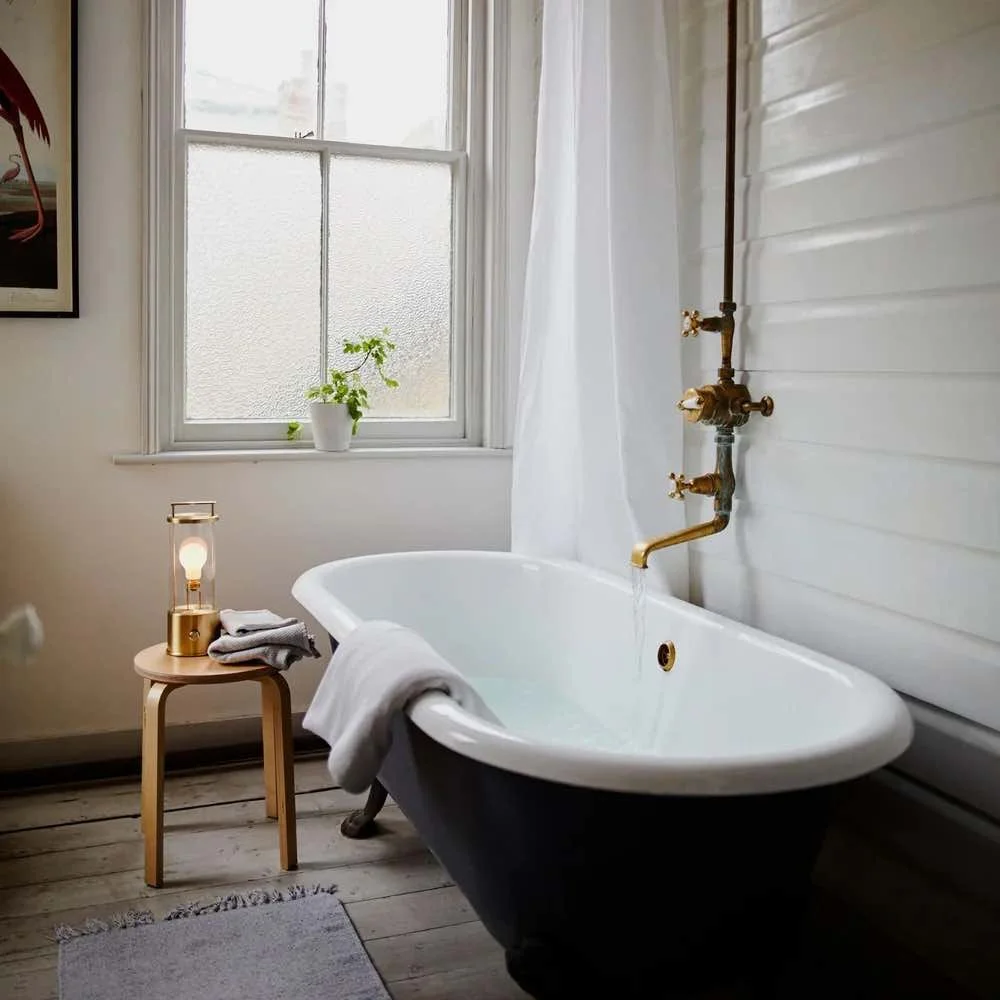 brass portable bathroom light by a country boat bath