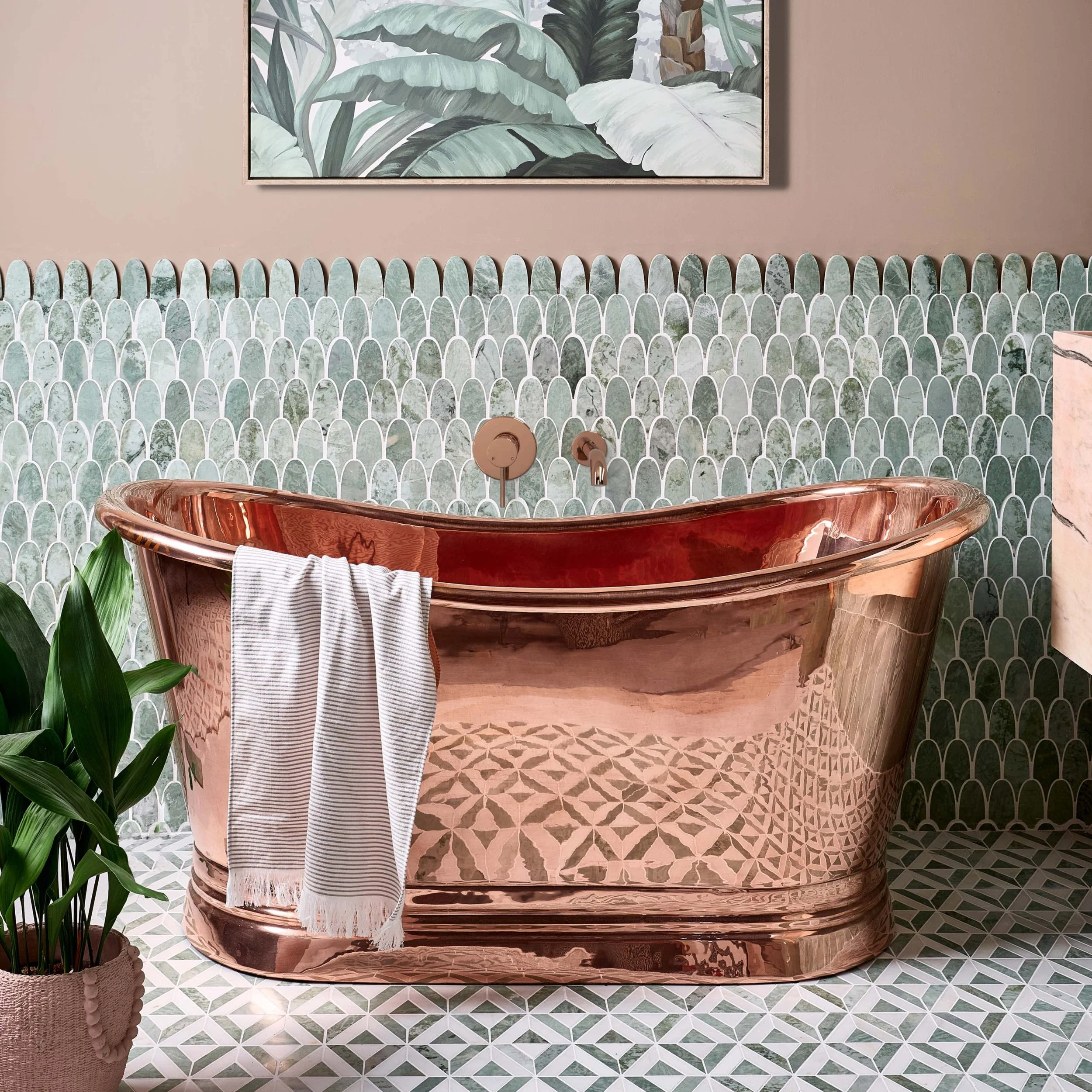 copper bath against green scalloped tiles