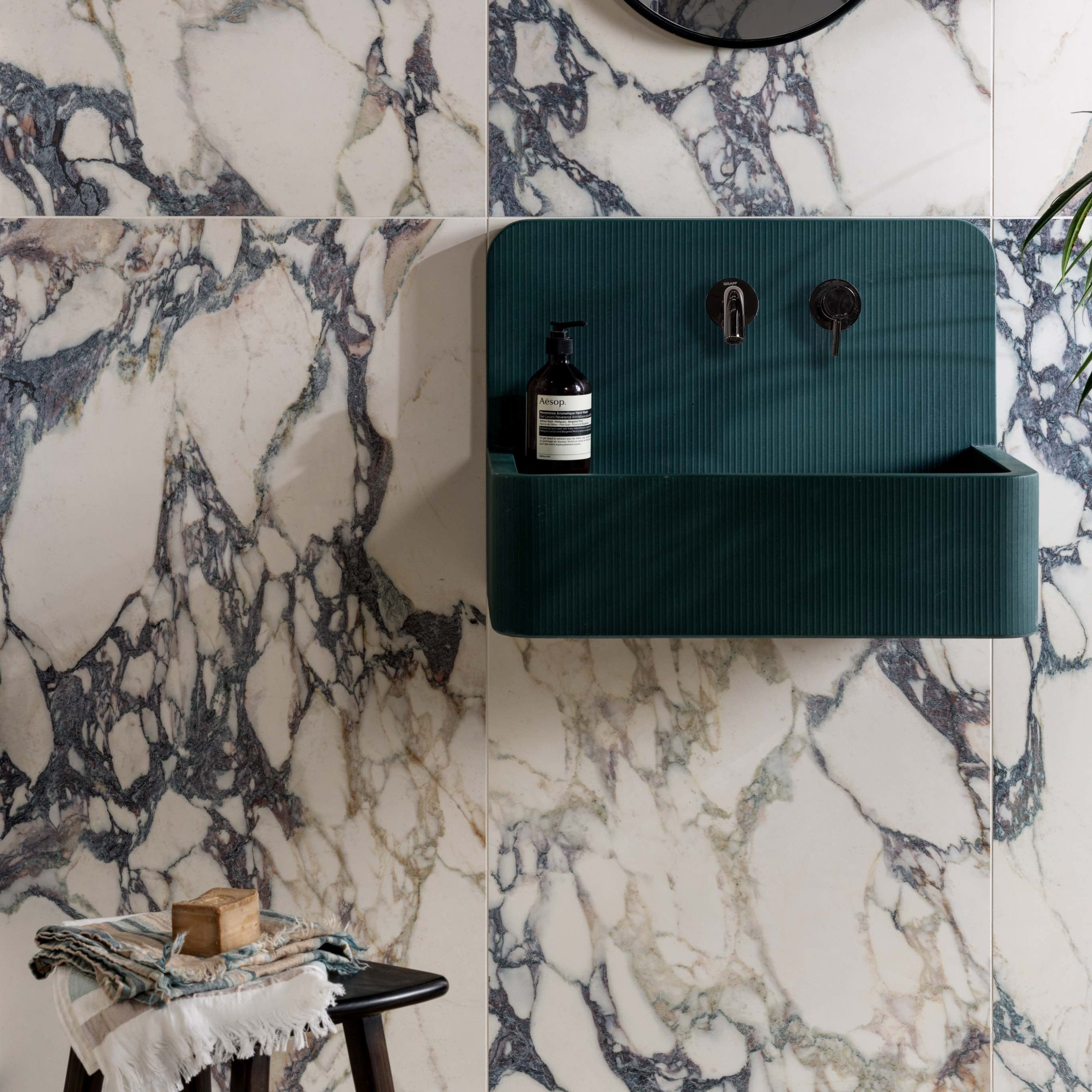 white and blue veined porcelain tile with blue basin