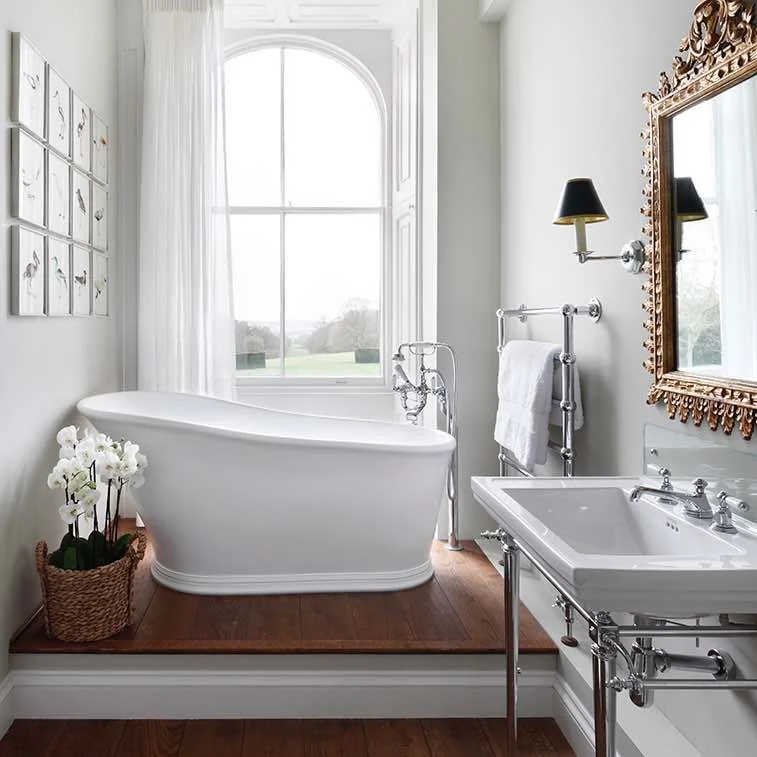 white slipper bath infront of large window