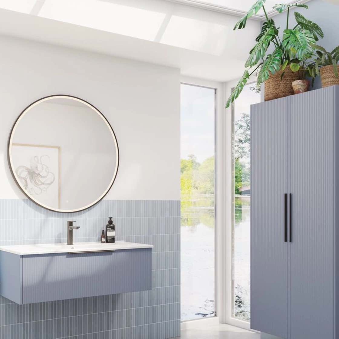 Blue vanity units in bright bathroom