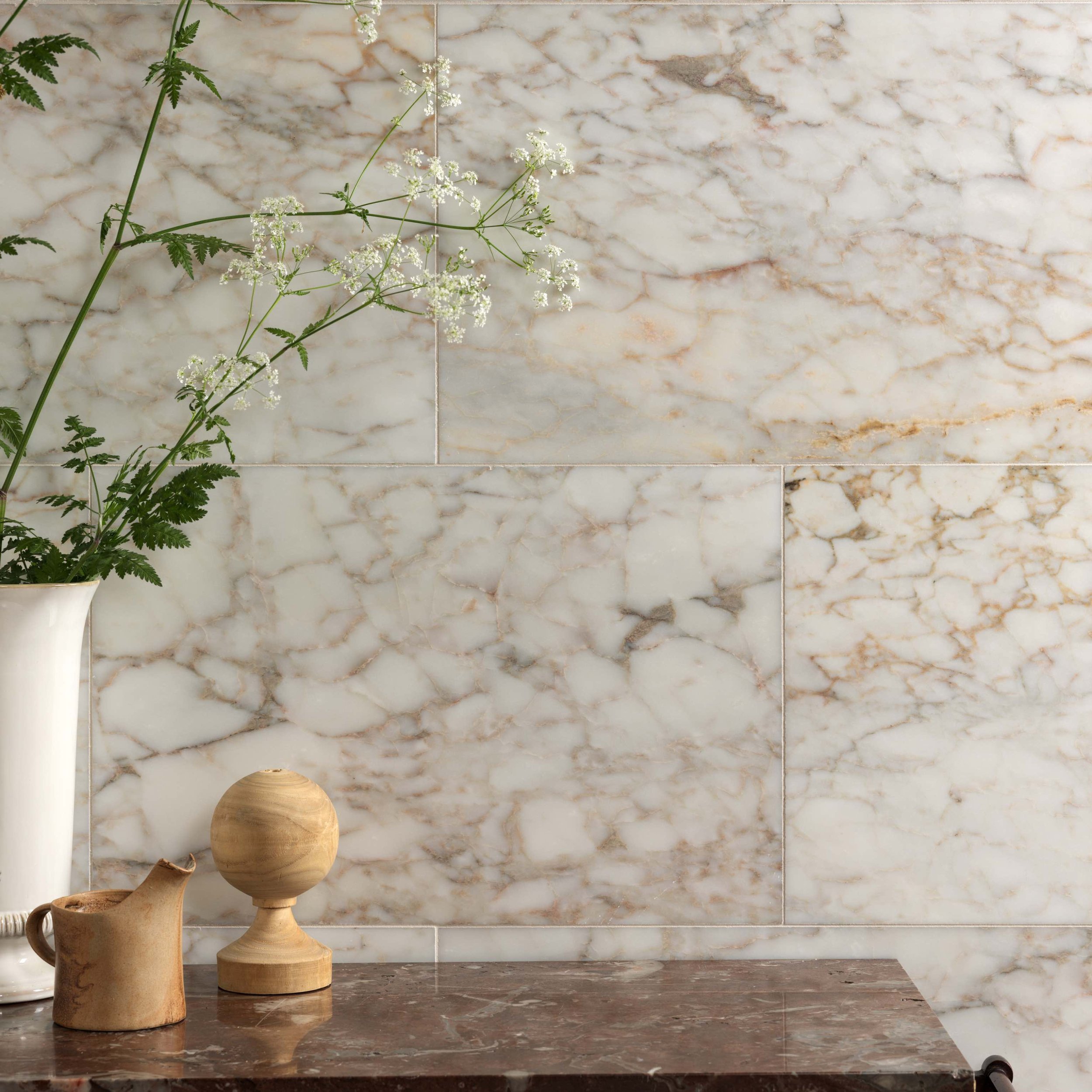 white and gold veined marble bathroom tile