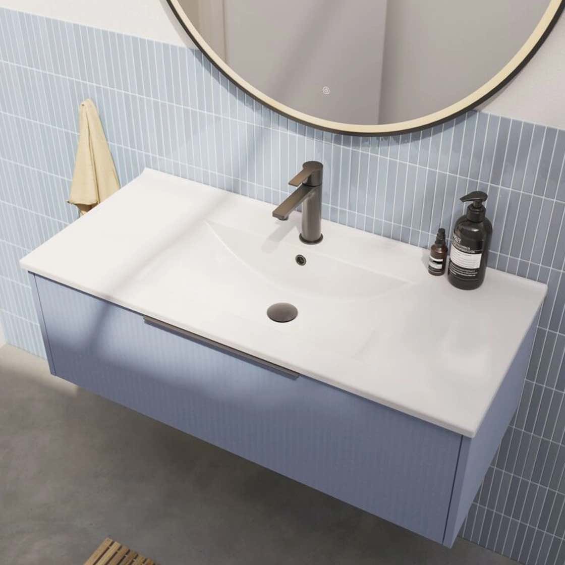 Close up of blue vanity units in bright bathroom
