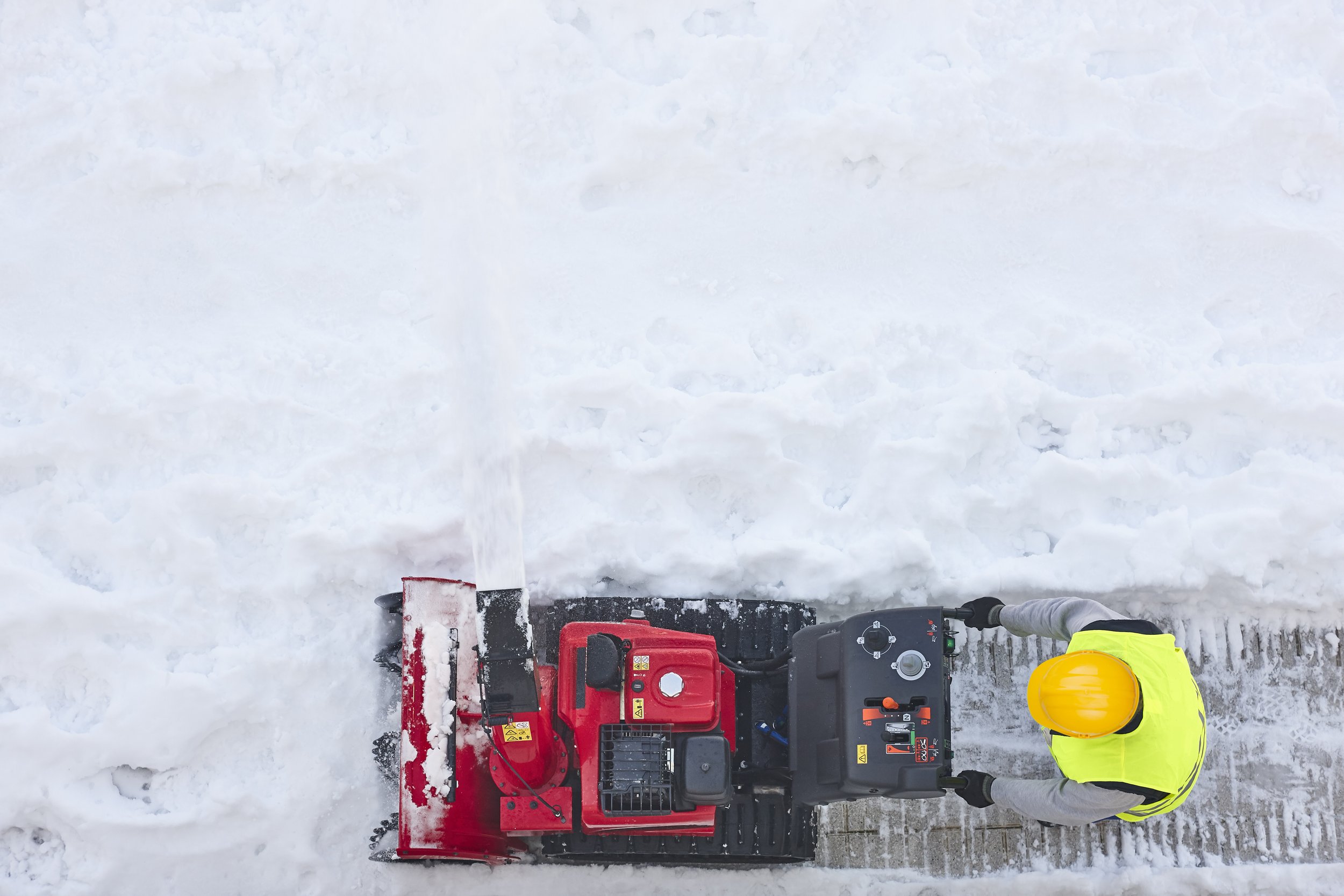 worker-cleaning-snow-on-the-sidewalk-with-a-snowbl-2023-11-27-05-35-41-utc.jpg