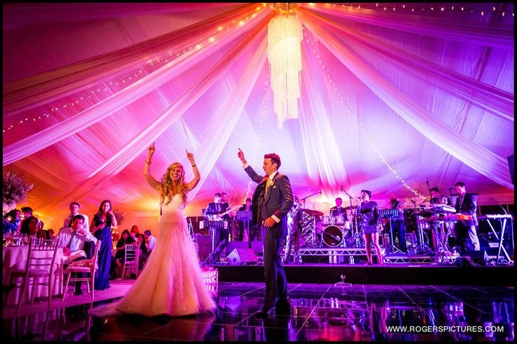 First dance in ivory lined wedding marquee with LED lighting