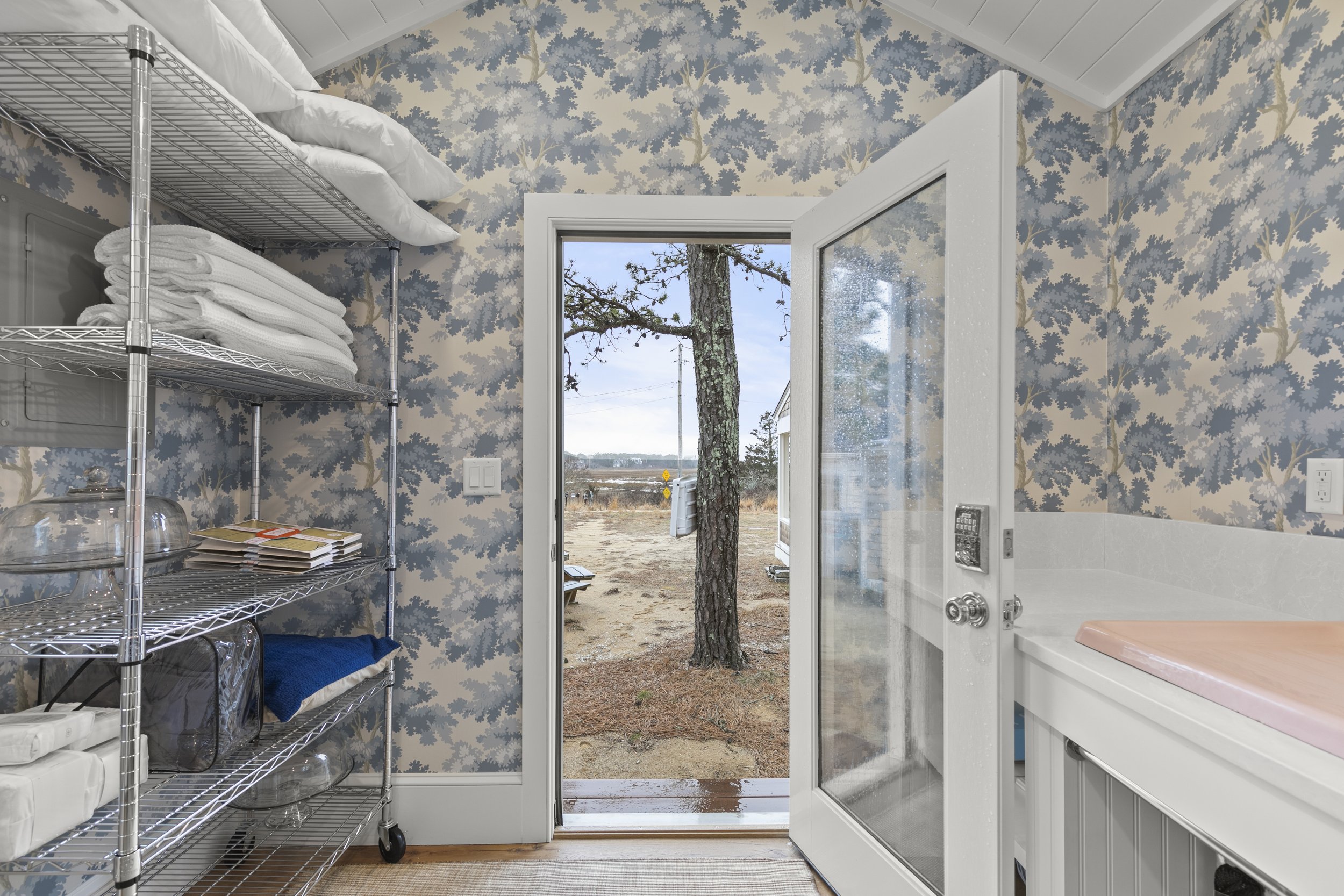 View of door to the laundry room showing extra linens
