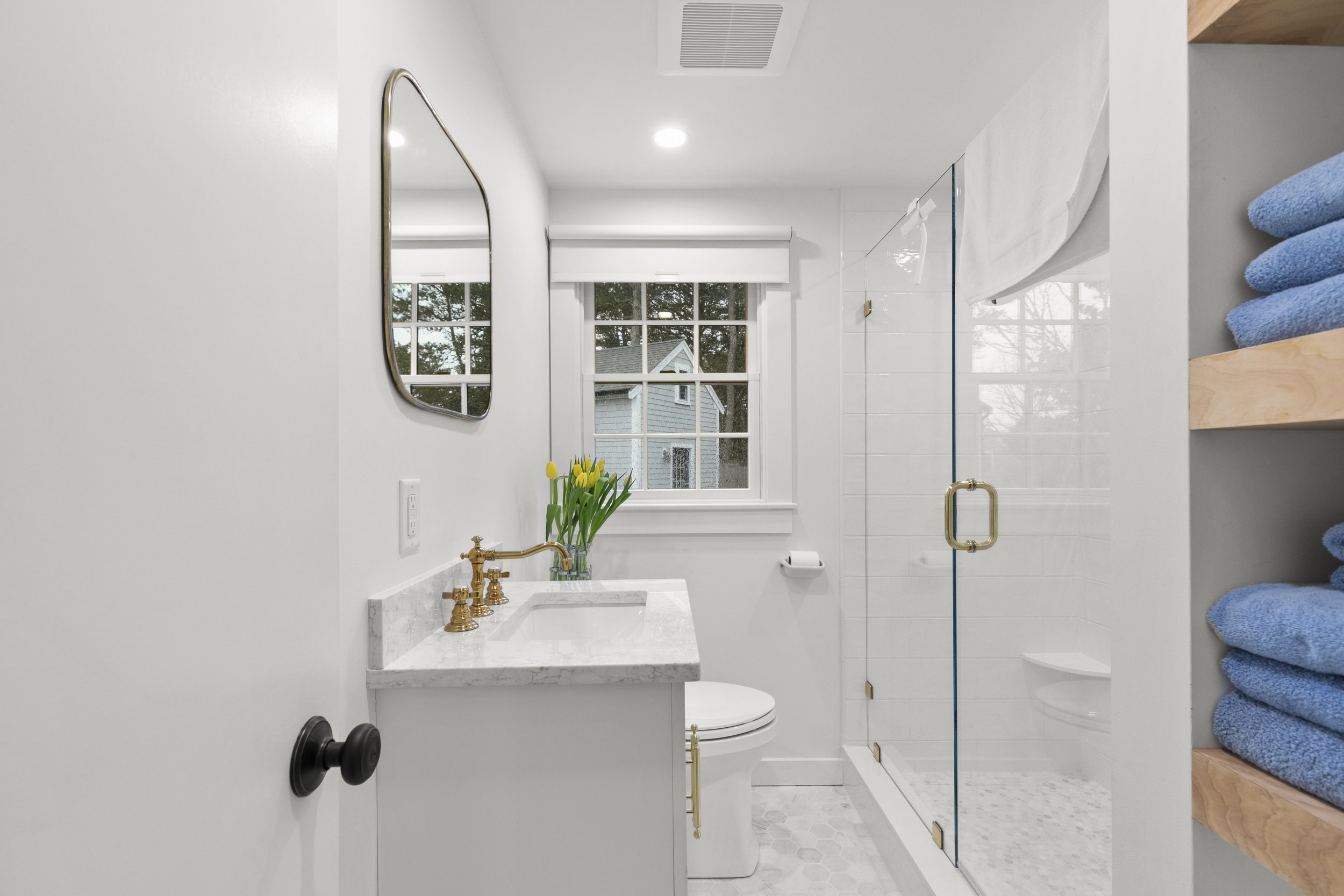 Full bathroom with walk-in shower and extra towels
