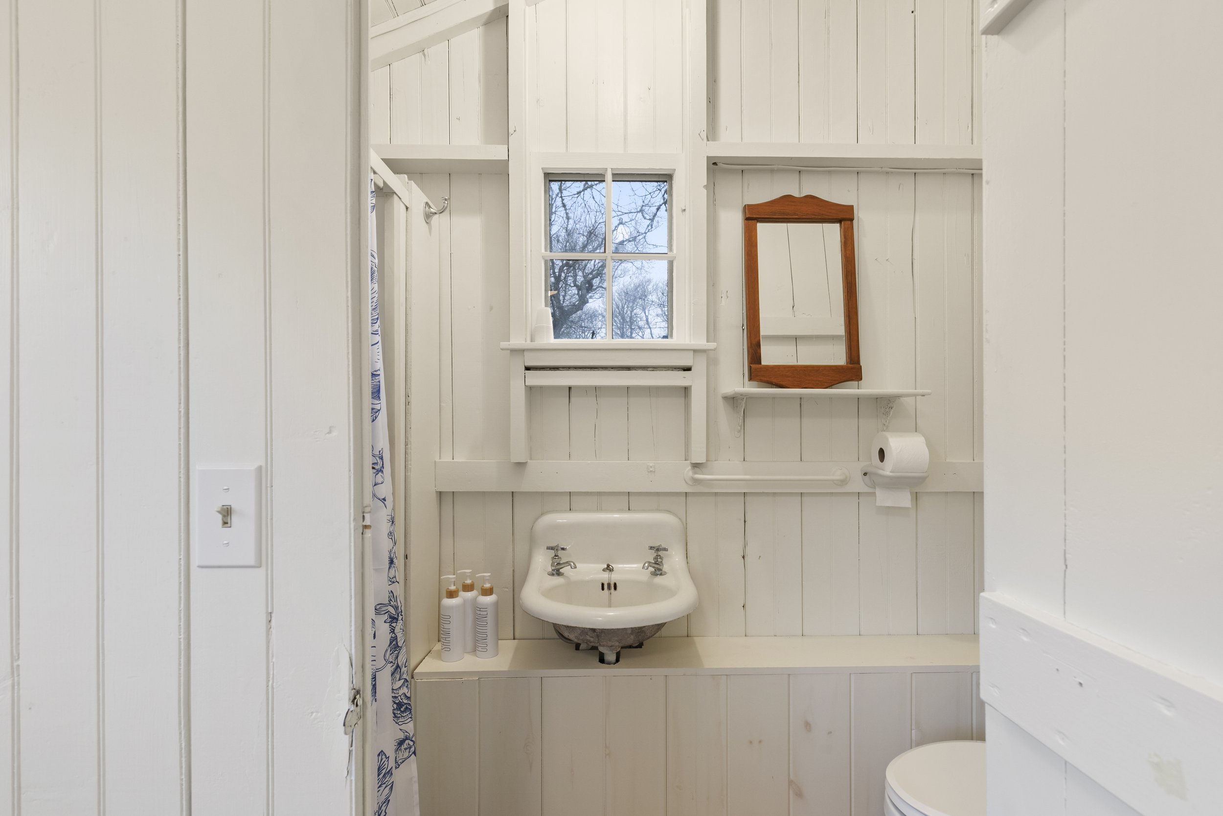 First floor bathroom with view of sink and window