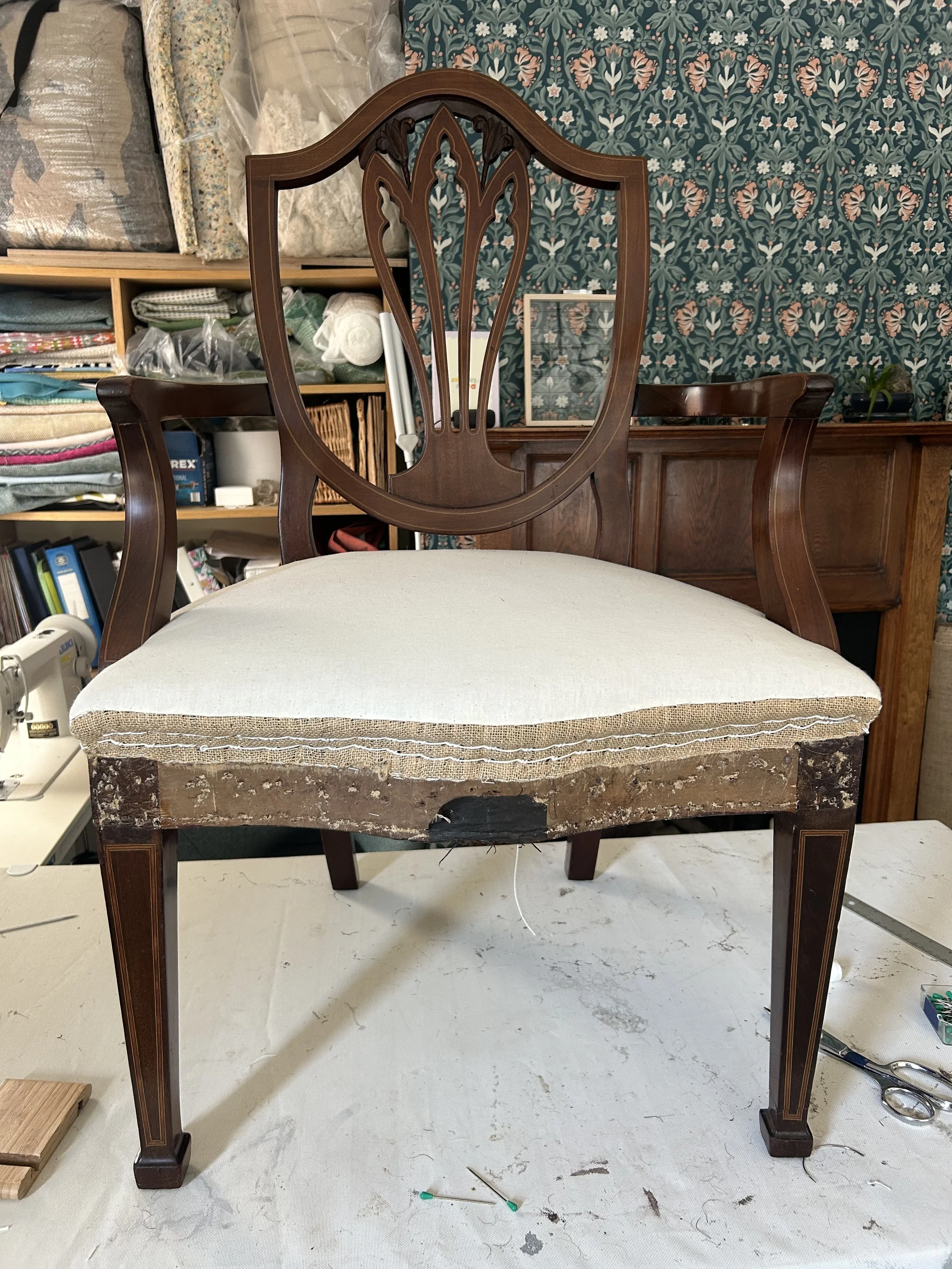 Layers of traditional materials and hand stitching lie beneath the top fabric in this antique chair