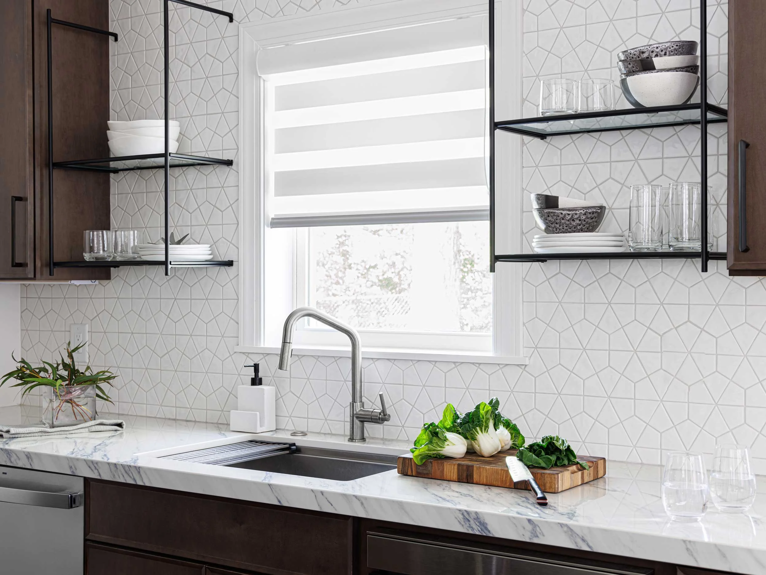 Streamlined contemporary kitchen renovation with custom cabinetry, banquette, and dining table at the Peregoy residence. Designed by Whitaker Interiors.