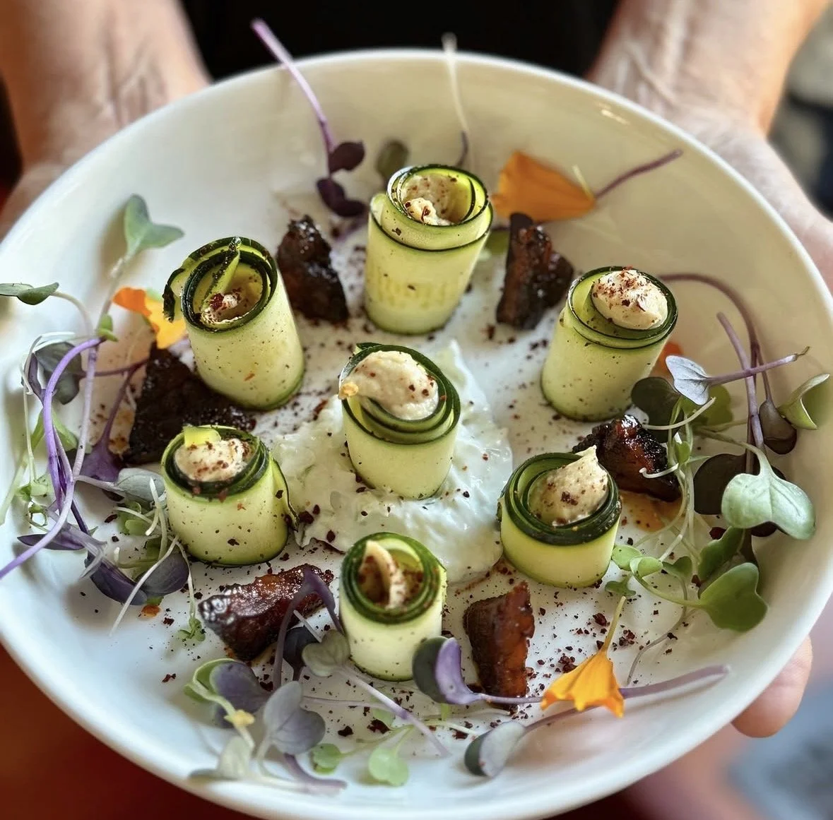 Zucchini Rolls with Smoked Cashew Cheese, Garlic-Cucumber Yogurt, and Blackened Tempeh Triangles