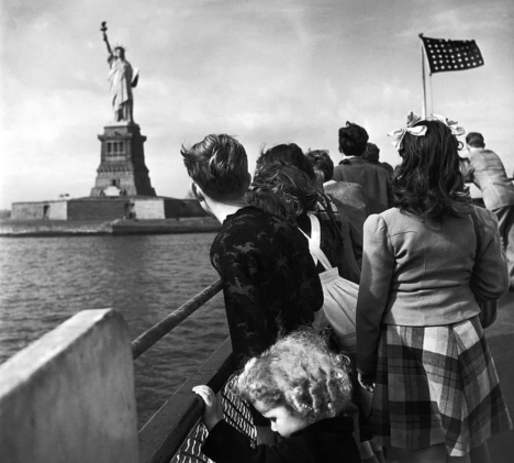 WWII refugee children viewing the Statue of Liberty as they enter the United States, 1946