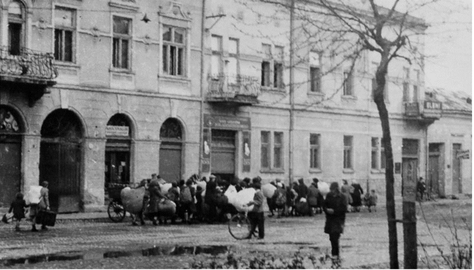 Deportation of Munkacs. Jews walked with their possessions along Mihaly Street and brought to the brick factory from where they were deported (Courtesy: Ghetto Fighters' Museum, Yad Vashem).