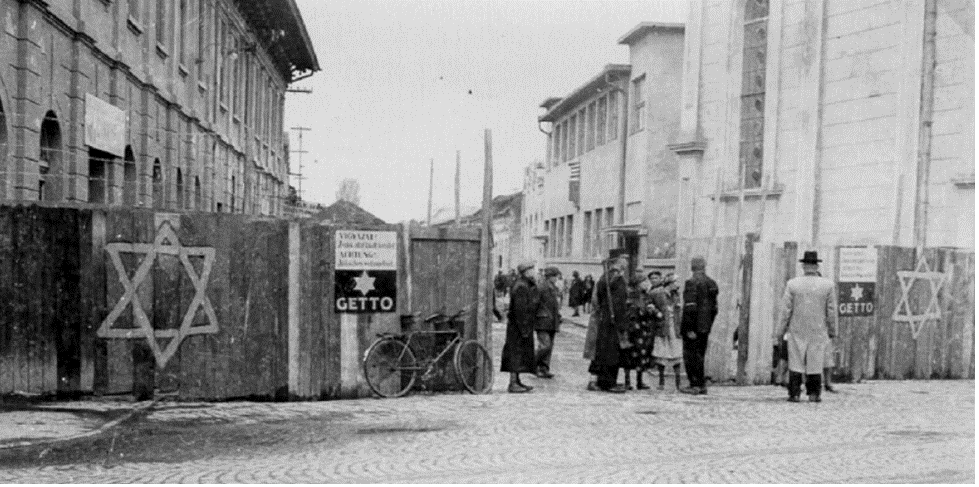 A Hungarian gendarme checks a woman entering the Munkacs ghetto (Courtesy: Ghetto Fighters' Museum, Yad Vashem).