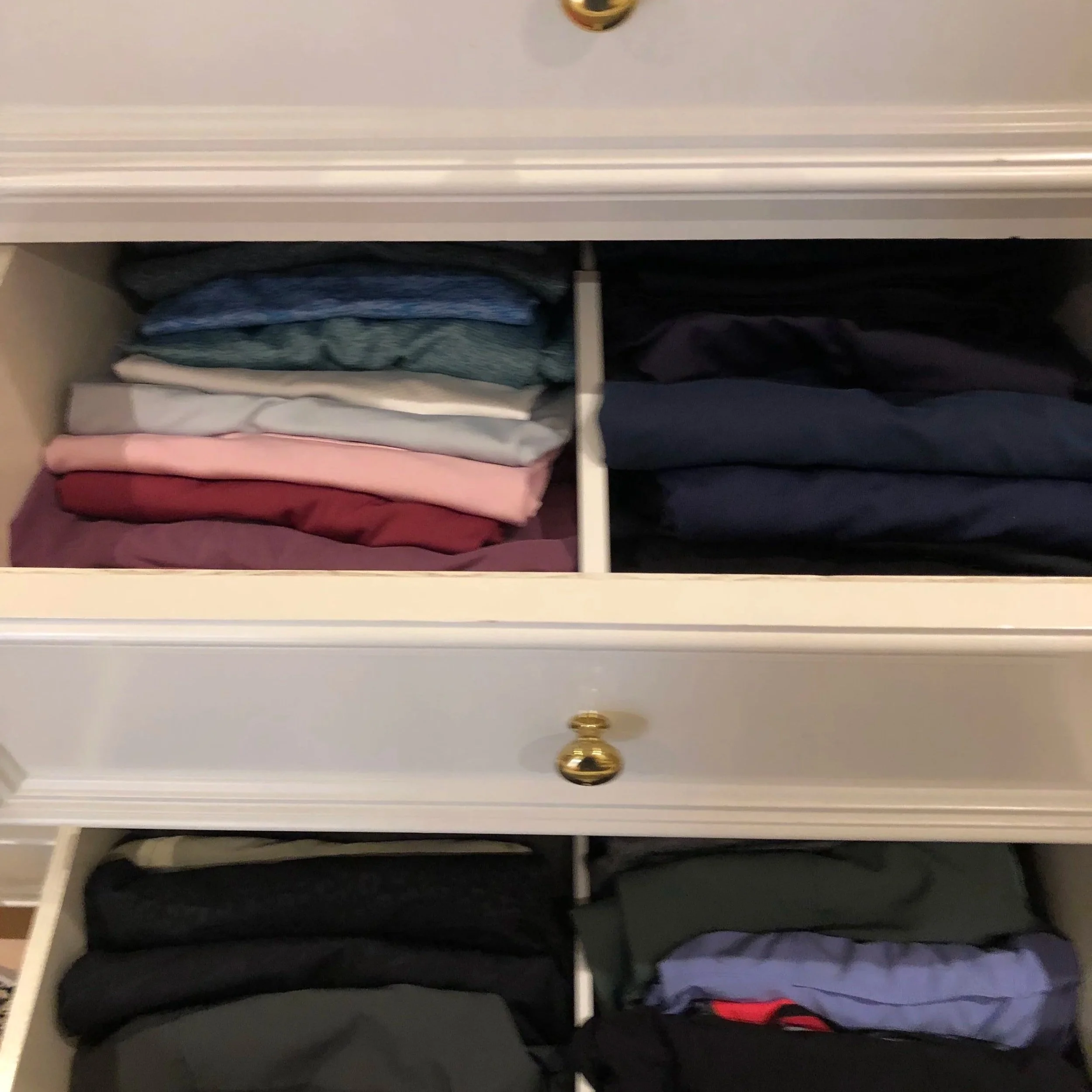 Two drawers displaying neatly folded clothing organized by Luxury Pro Organizer.