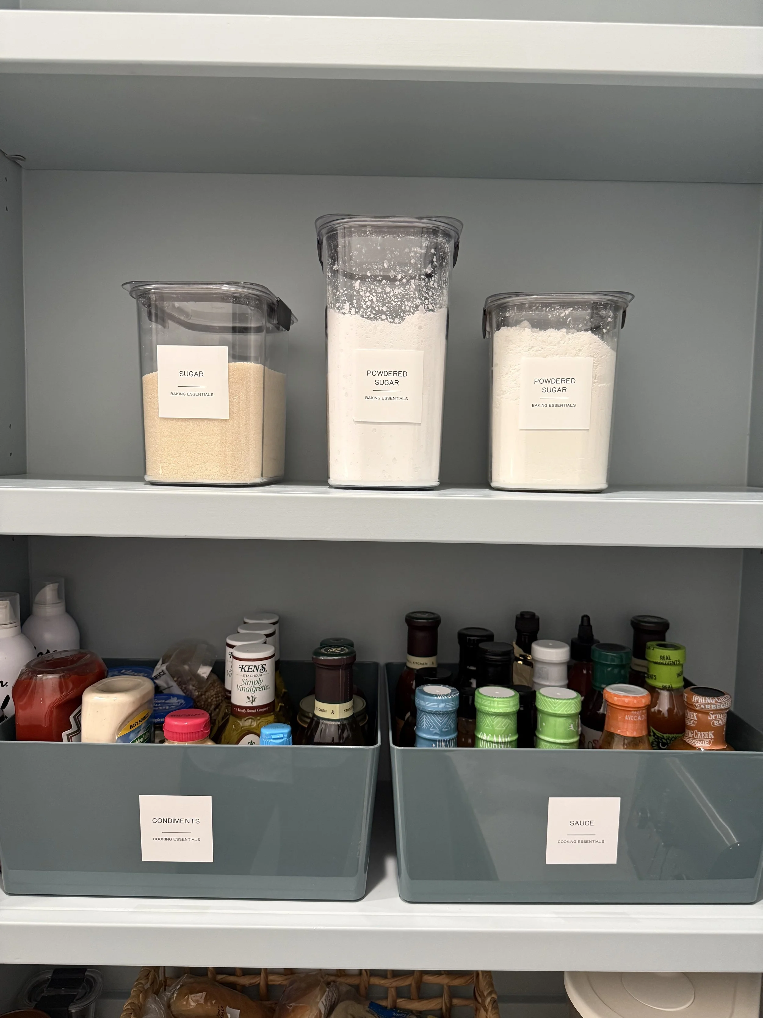organized and styled Woodlands, Texas pantry with green labeled containers and clear canisters