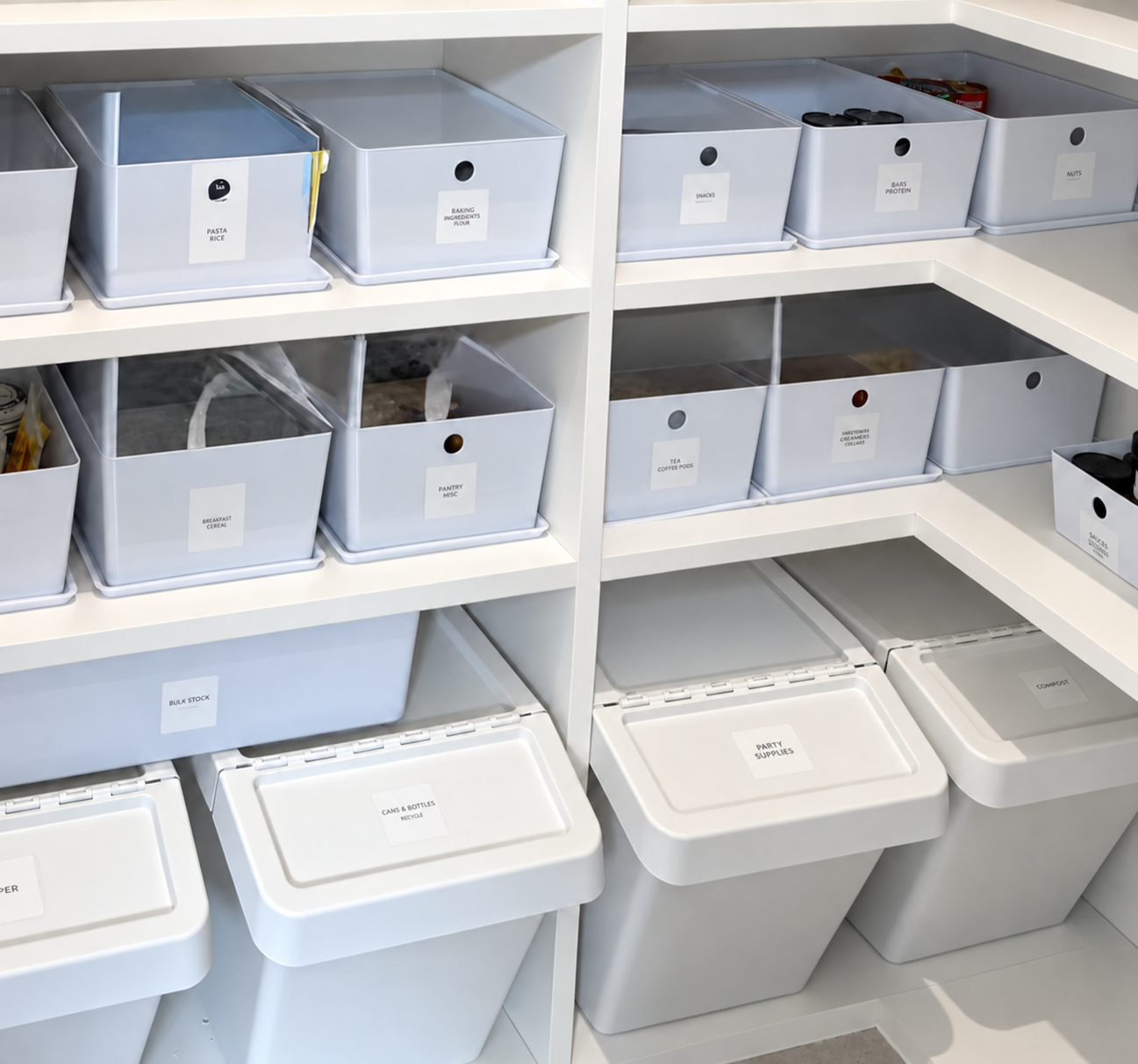 Organized and labeled white containers on white shelves in a pantry in West U, houston