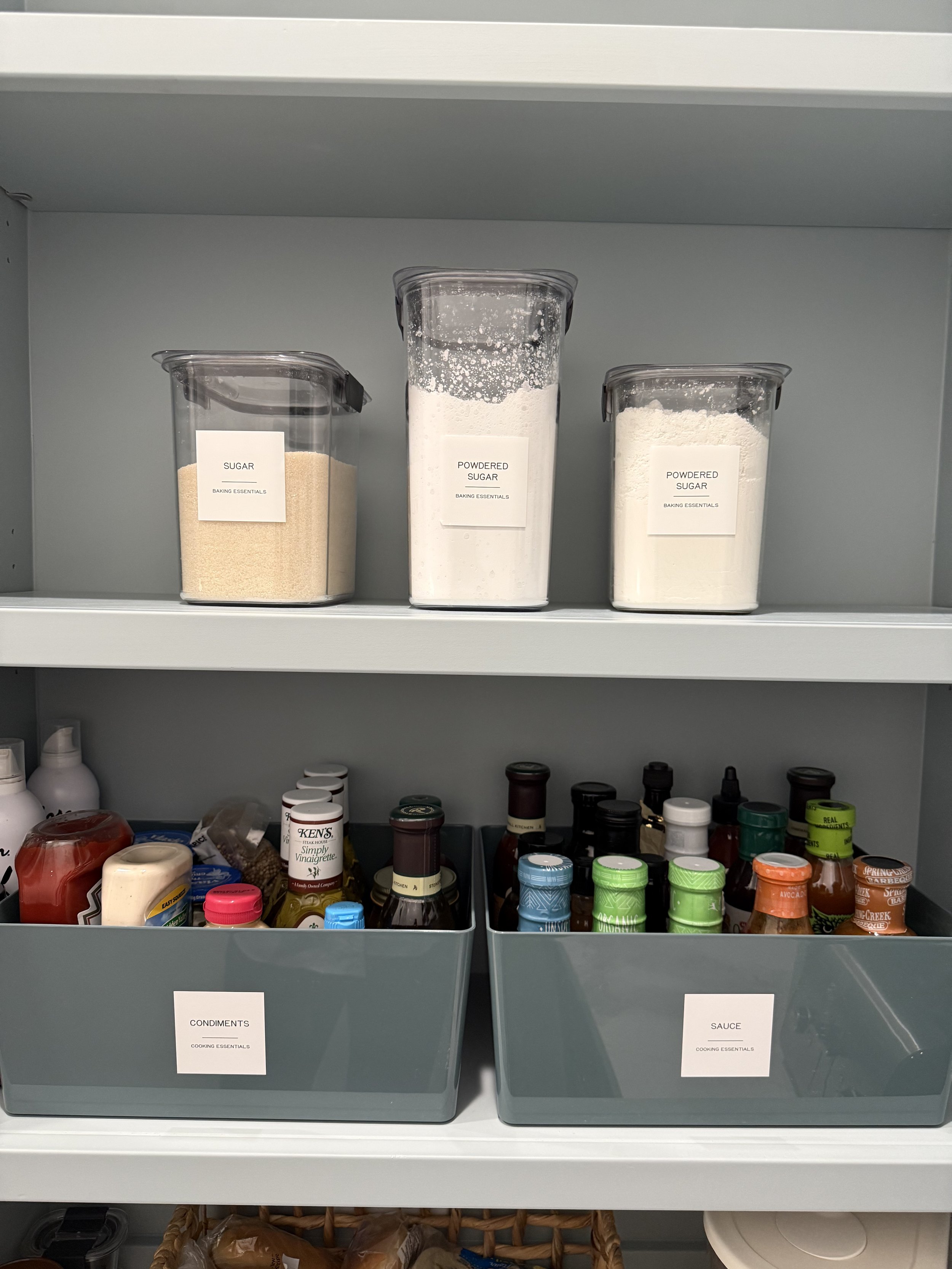Clearly labeled pantry containers for sugar, baking ingredients, and condiments organized by Luxury Pro Organizer to create a luxury, functional kitchen pantry in Woodlands, Texas.
