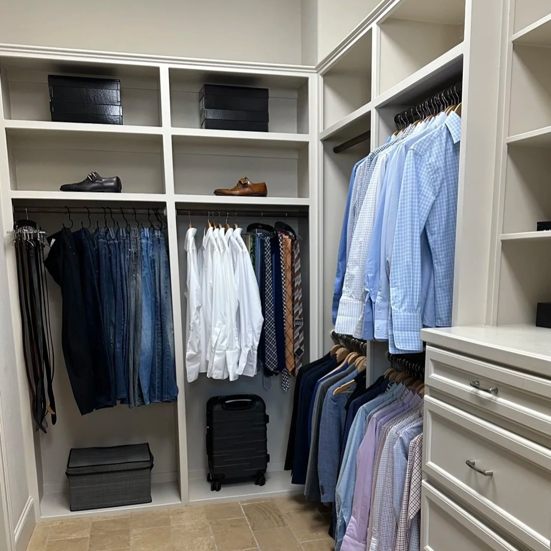 Men’s closet in River Oaks with shirts grouped by color, folded clothing, and shoes arranged on shelves.