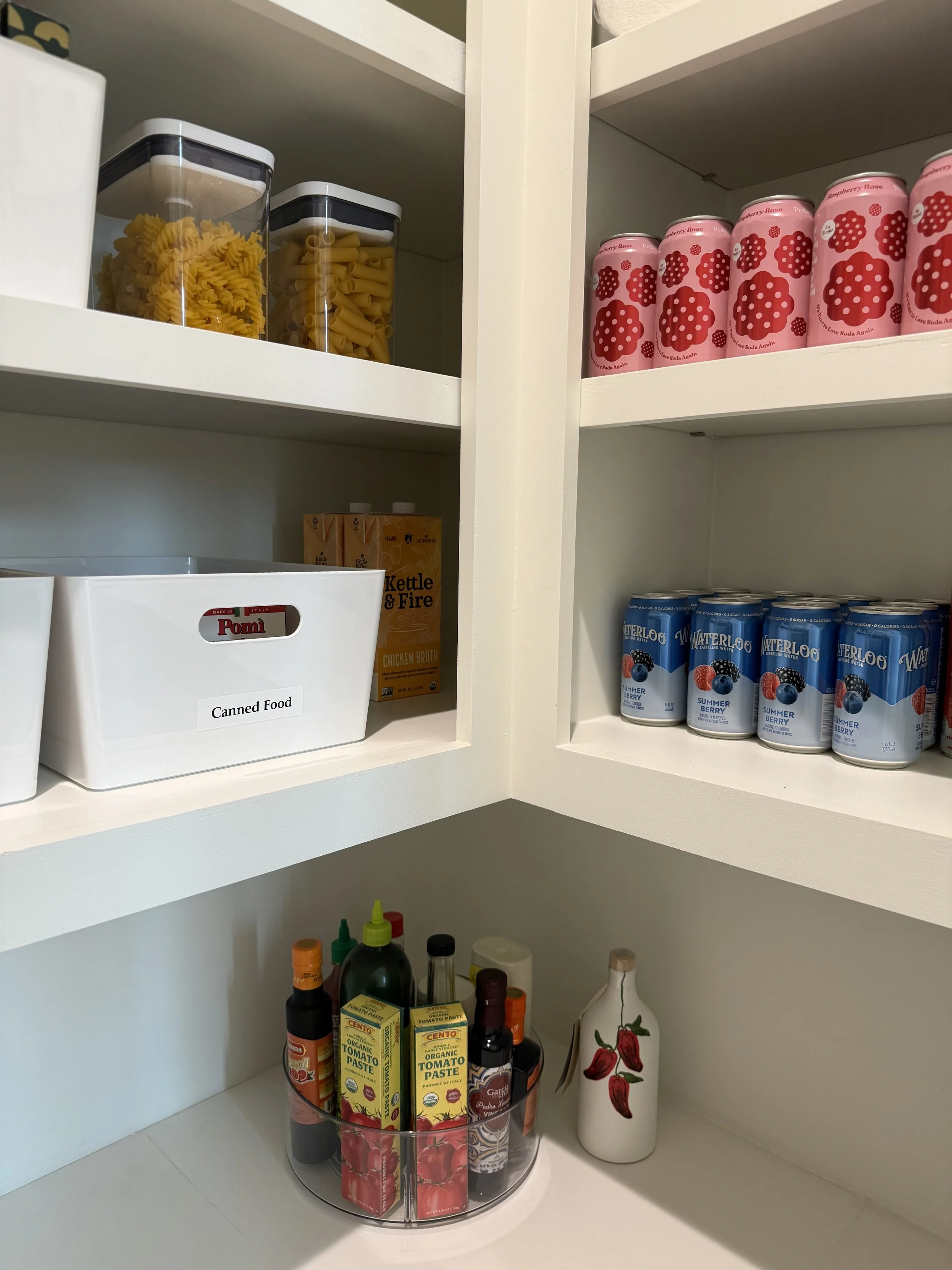 Pantry organized by Luxury Pro Organizer with sodas, pasta, and sauces